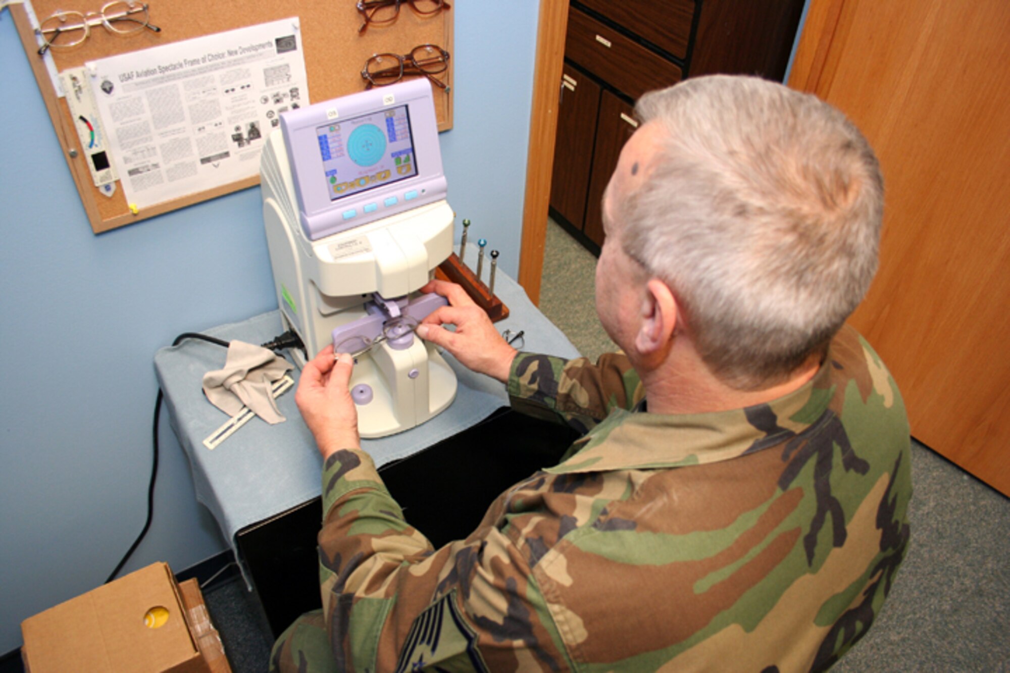 GRISSOM AIR RESERVE BASE, Ind., -- Master Sgt. Ed Lampa, NCOIC of the 434th Aerospace Medicine Squadron optical clinic uses a lensometer to check a prescription lens for accuracy during the December unit training assembly. (Air Force photo/ Staff Sgt. Chris Bolen)