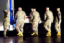 An Army carry team places a transfer case containing a fallen servicemember into a vehicle during a “dignified transfer” at Dover Air Force Base, Del., Feb. 22.. The vehicle will transport the case to the Air Force Mortuary Affairs Operations Center, where all U.S. servicemembers killed in combat are prepared for burial. (U.S. Air Force photo/Roland Balik) 