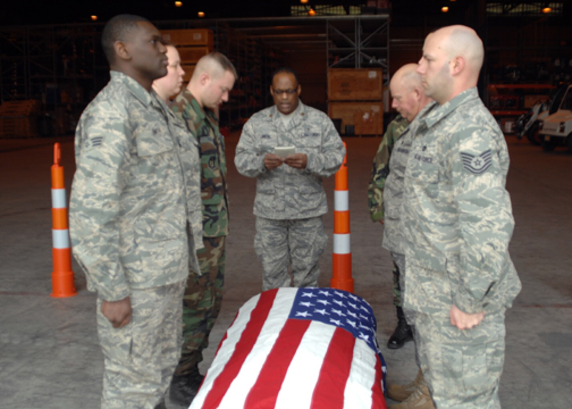GRISSOM AIR RESERVE BASE, Ind. -- Chaplain (Maj.) Obadiah Smith, 434th Air Refueling Wing chaplain, recites a prayer while members of the aerial port flight stand at attention during dignified transfer training. (U.S. Air Force photo/Senior Airman Carl Berry)