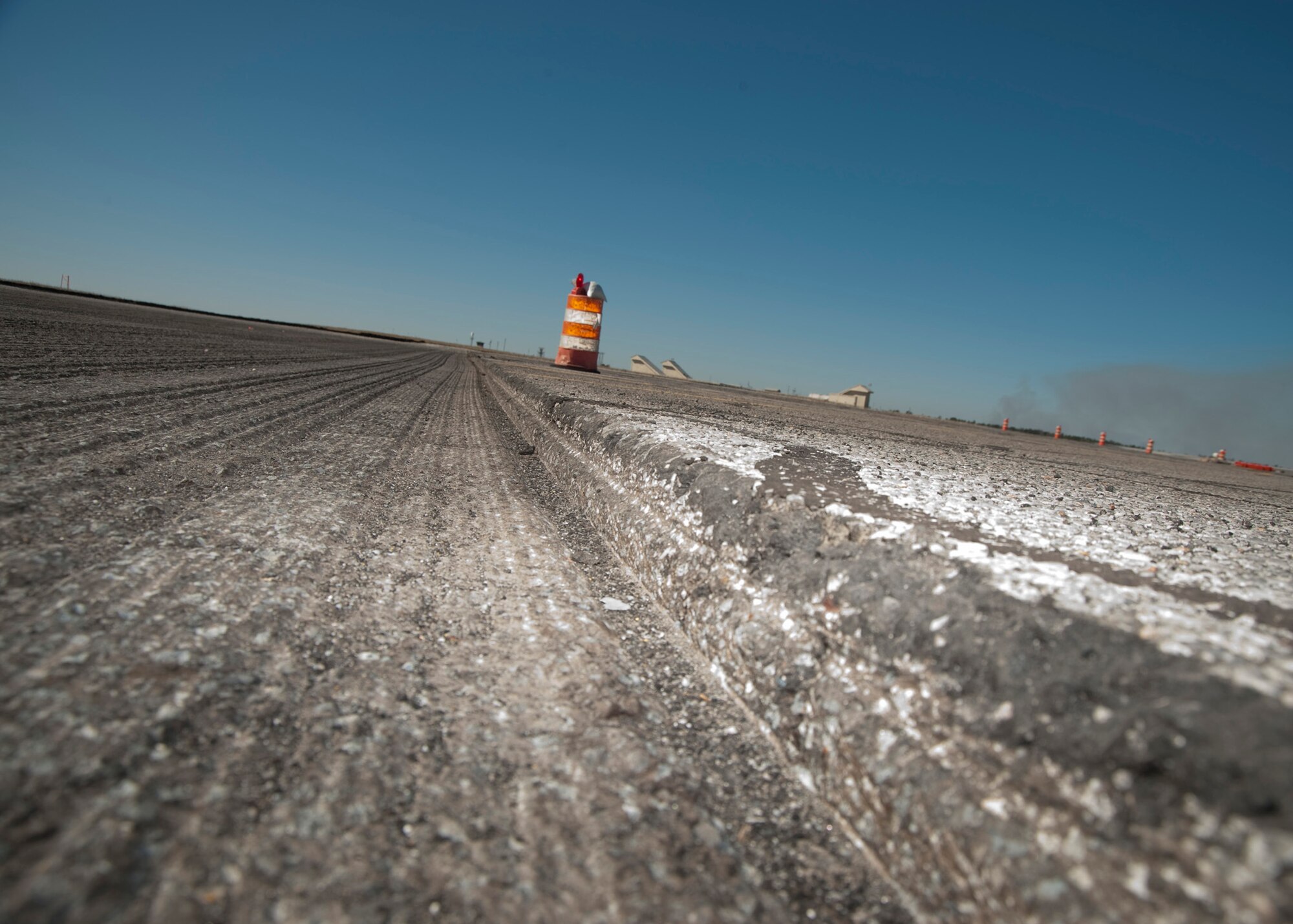 A line of asphalt was cleared by the RX-900 in February at Eglin Air Force Base, Fla.  This was part of the six-month repaving and construction on Runway 19/01.  The runway reopened March 15 to air traffic.  (Courtesy photo.)