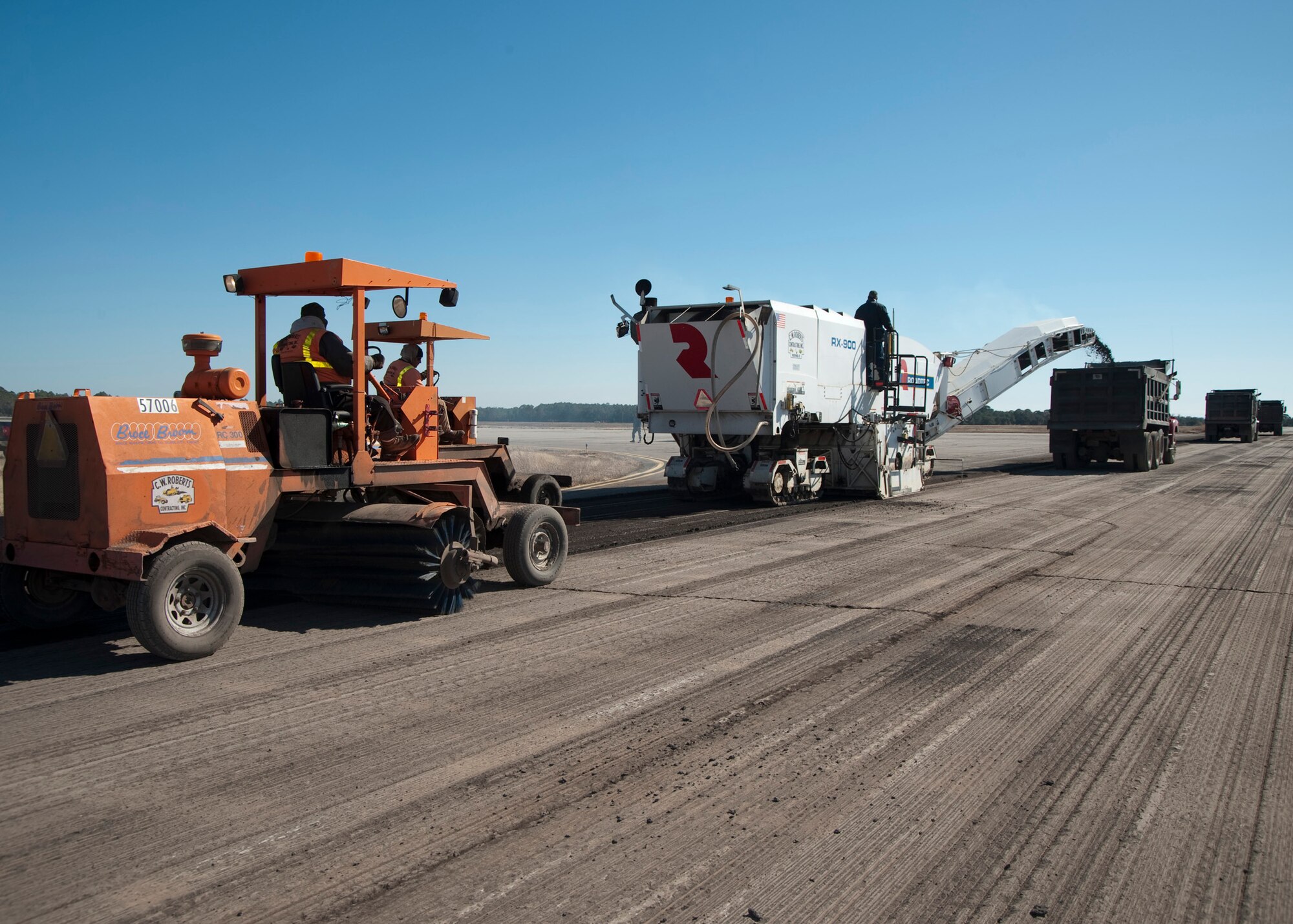 Asphalt is ground up and shot out by the RX-900 in February at Eglin Air Force Base, Fla.  This was part of the six-month repaving and construction on Runway 19/01.  The runway reopened March 15 to air traffic.  (Courtesy photo.)