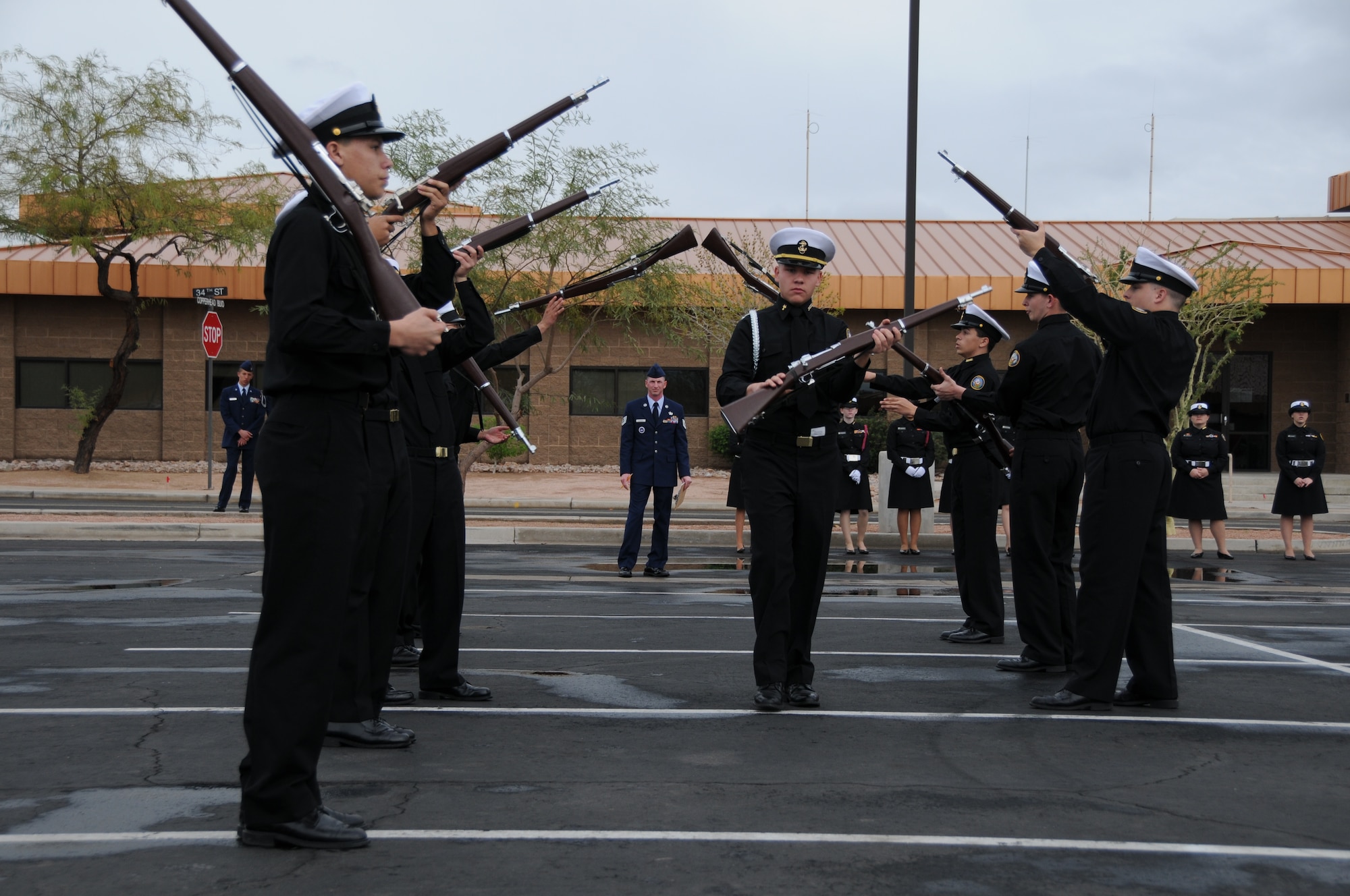 A Navy Junior ROTC drill team performs rifle tosses as part of the exhibition performance during a drill team competition at the base February 20, 2010. This ten man team was just one of 28 schools from around the state of Arizona and Texas that competed here today. (U.S. Air Force Photo by Senior Airman Nicole Enos)