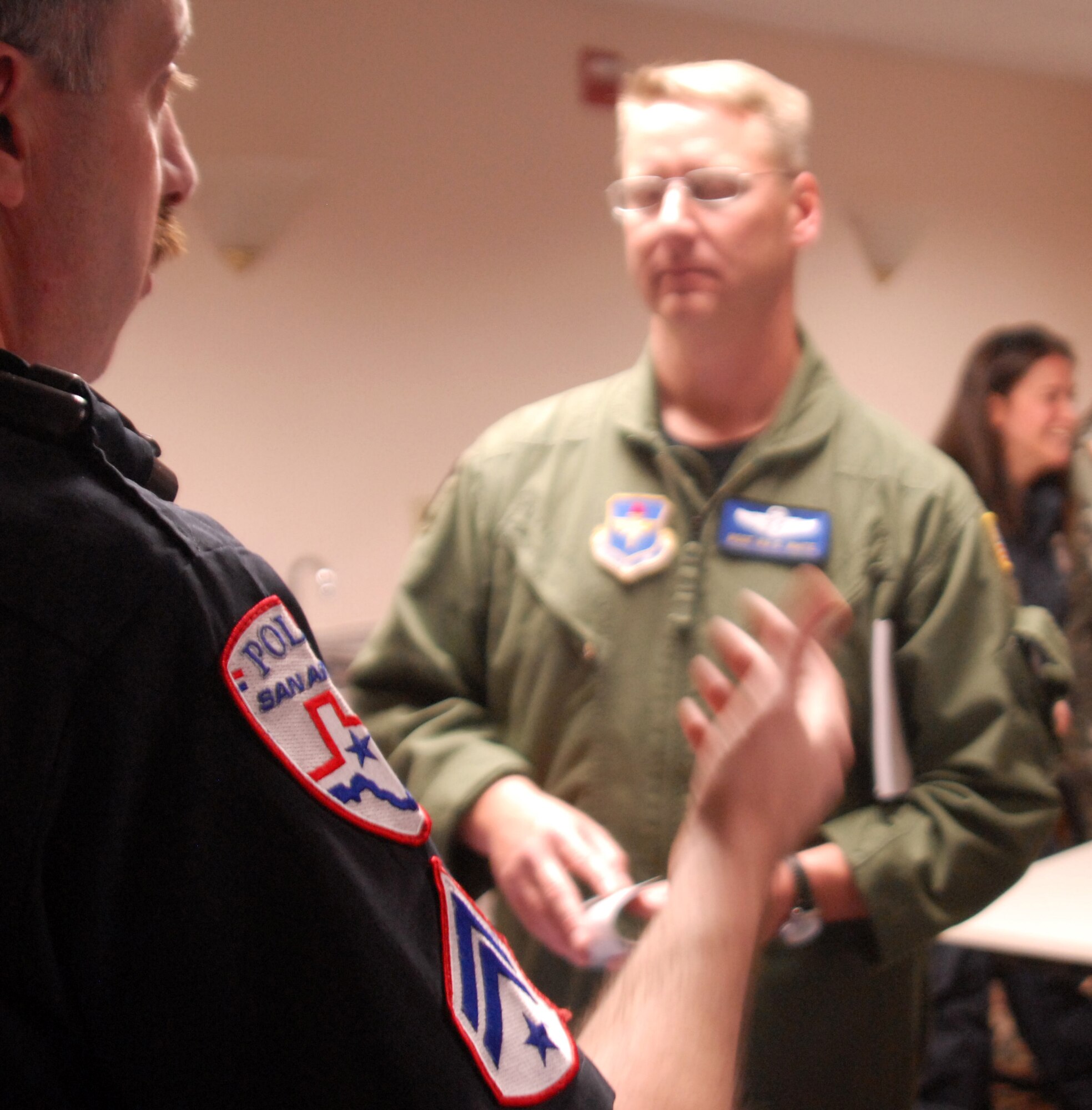 Officer Tim Coffman of the San Angelo Police Department, Texas, talks to Master Sgt. Ira White, 316th Training Squadron about employment opportunities with his department during the Airman and Family Readiness law enforcement job fair on Goodfellow AFB, March 12.  Several law enforcement agencies were on hand to speak to prospective employees from the base.  (U.S. Air Force Photo/Robert D. Martinez)