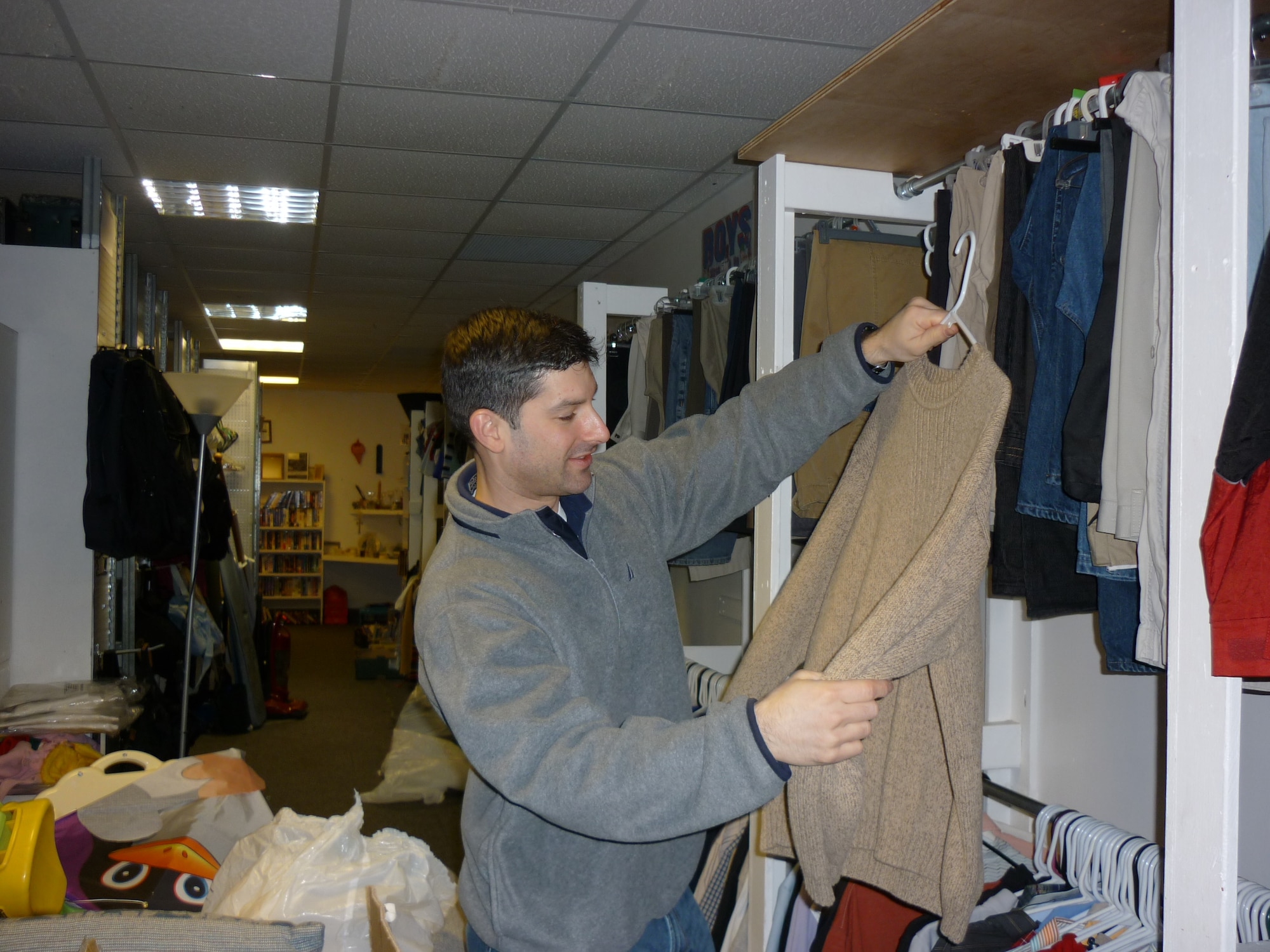 2nd Lt. Kristofer Figueroa, 48th Logistics Readiness Squadron vehicle management acting flight commander, sorts through articles of clothing to determine what is serviceable while volunteering at the RAF Lakenheath Airman’s Attic Feb. 20. (U.S. Air Force photo by 2nd Lt. Ashley Skillman)