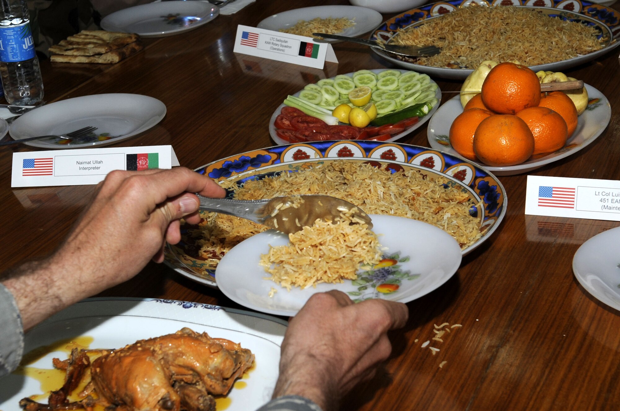 Maj. Gen. Abdul  Raziq Sherzai, Kandahar Air Wing commander, presents members of the 451st Air Expeditionary Wing with a traditional Afghan meal as a form of commodore March 10 at his compound in Kandahar, Af.  (U.S. Air Force photo by Senior Airman Nancy Hooks/Released)