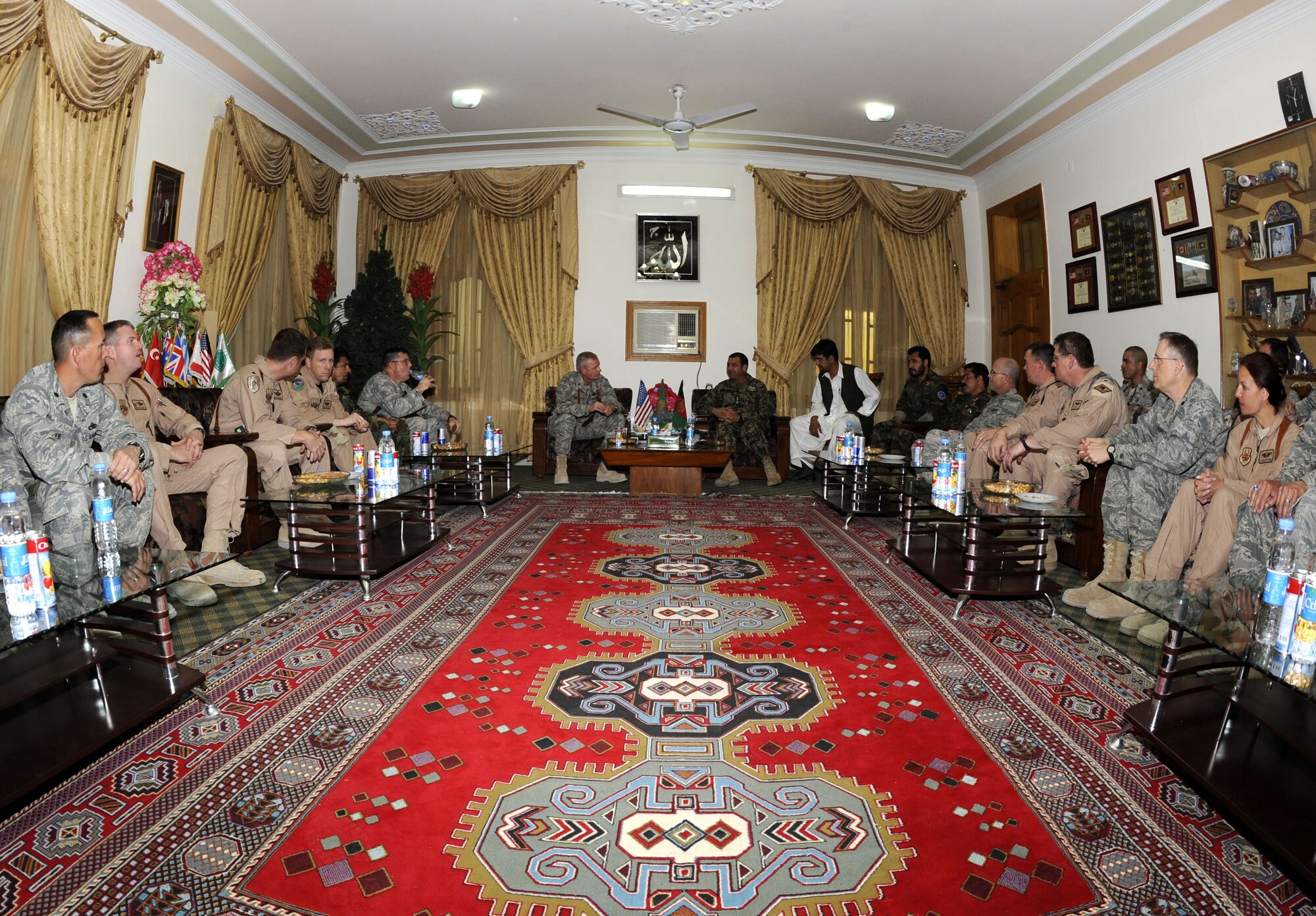 Members of the 451st Air Expeditionary Wing share commodore with Maj. Gen. Abdul  Raziq Sherzai, Kandahar Air Wing commander, at his compound March 10 in Kandahar, Af.  General Sherzai invited members of the 451st Air Expeditionary Wing to have a traditional Afghan meal.  (U.S. Air Force photo by Senior Airman Nancy Hooks/Released)