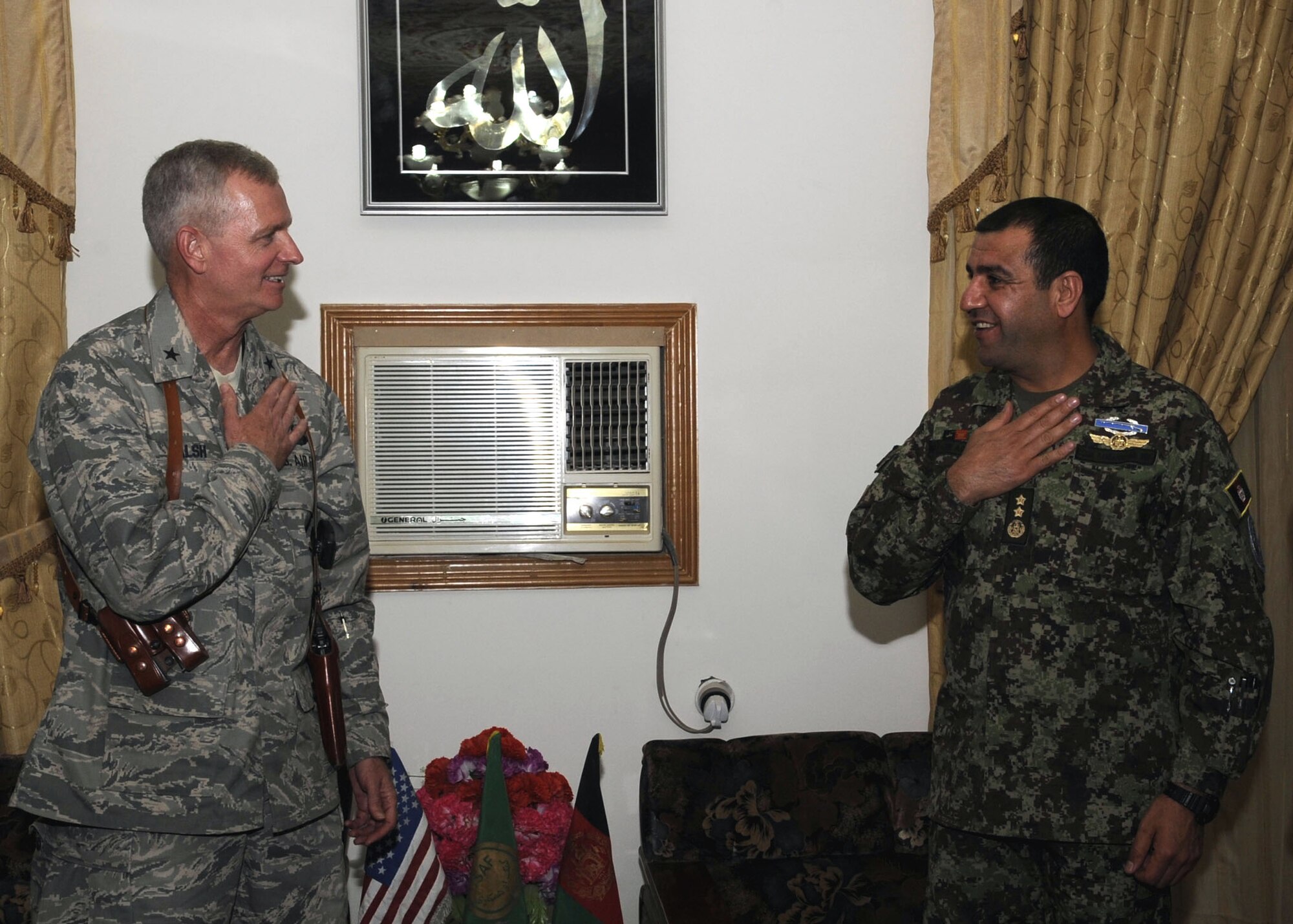 Brigadier Gen. Guy Walsh, 451st Air Expeditionary Wing commander, greets Maj. Gen. Abdul Raziq Sherzai, Kandahar Air Wing commander, March 10 at his compound in Kandahar, Afghanistan.  General Sherzai invited members of the 451st Air Expeditionary Wing to have a traditional Afghan meal.  General Walsh is the senior mentor tto the Kandahar Air Wing of the Afghan National Army Air Corps. (U.S. Air Force photo by Senior Airman Nancy Hooks/Released)
