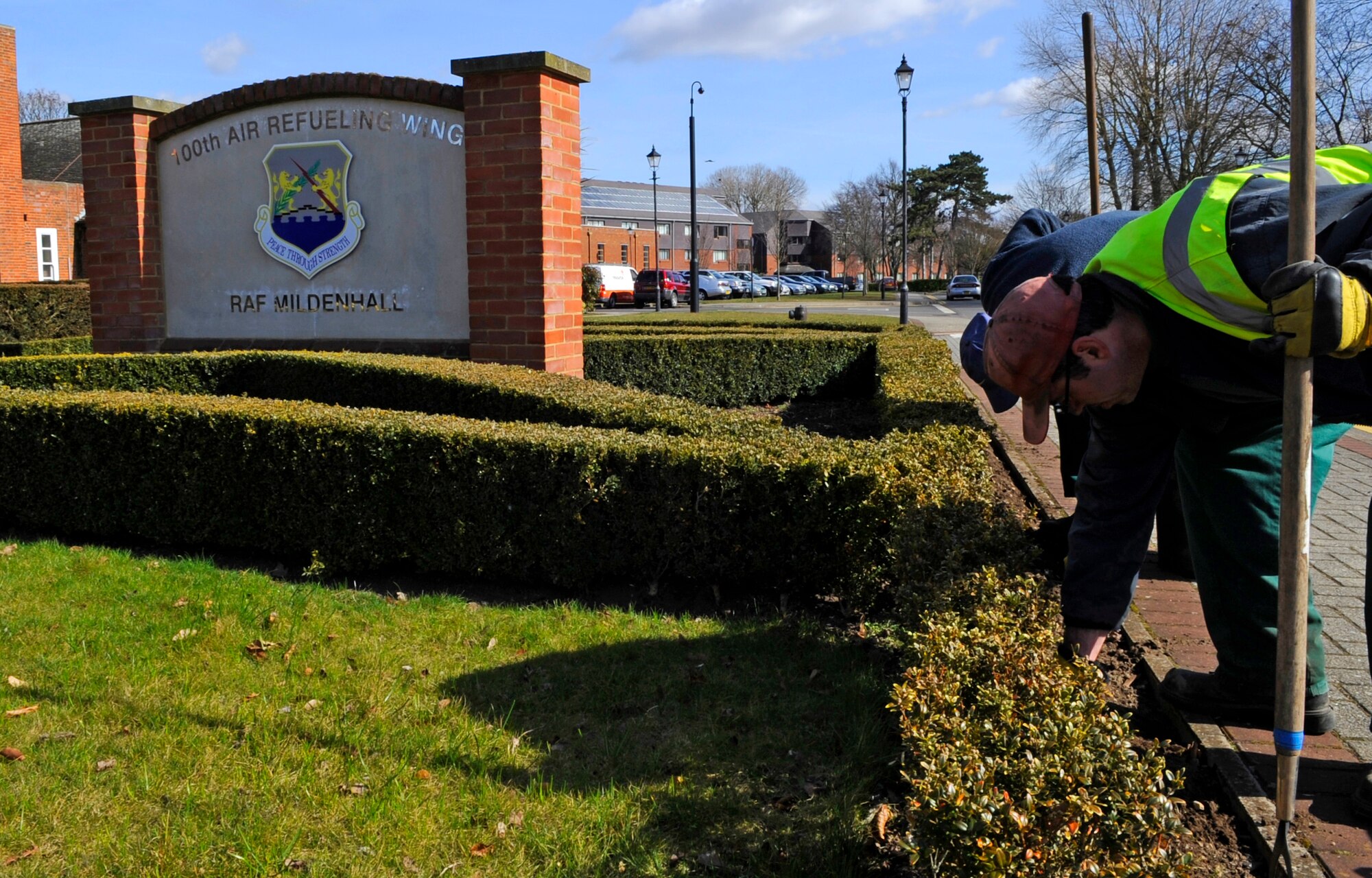 RAF MILDENHALL, England – Glyn Tunny and Matthew Spooner, local landscape contractors, prepare the flower beds for spring flowers at the 100th Air Refueling Wing headquarters building March 15.  Spring officially starts March 20.  (U.S. Air Force photo/Staff Sgt. Christopher L. Ingersoll)