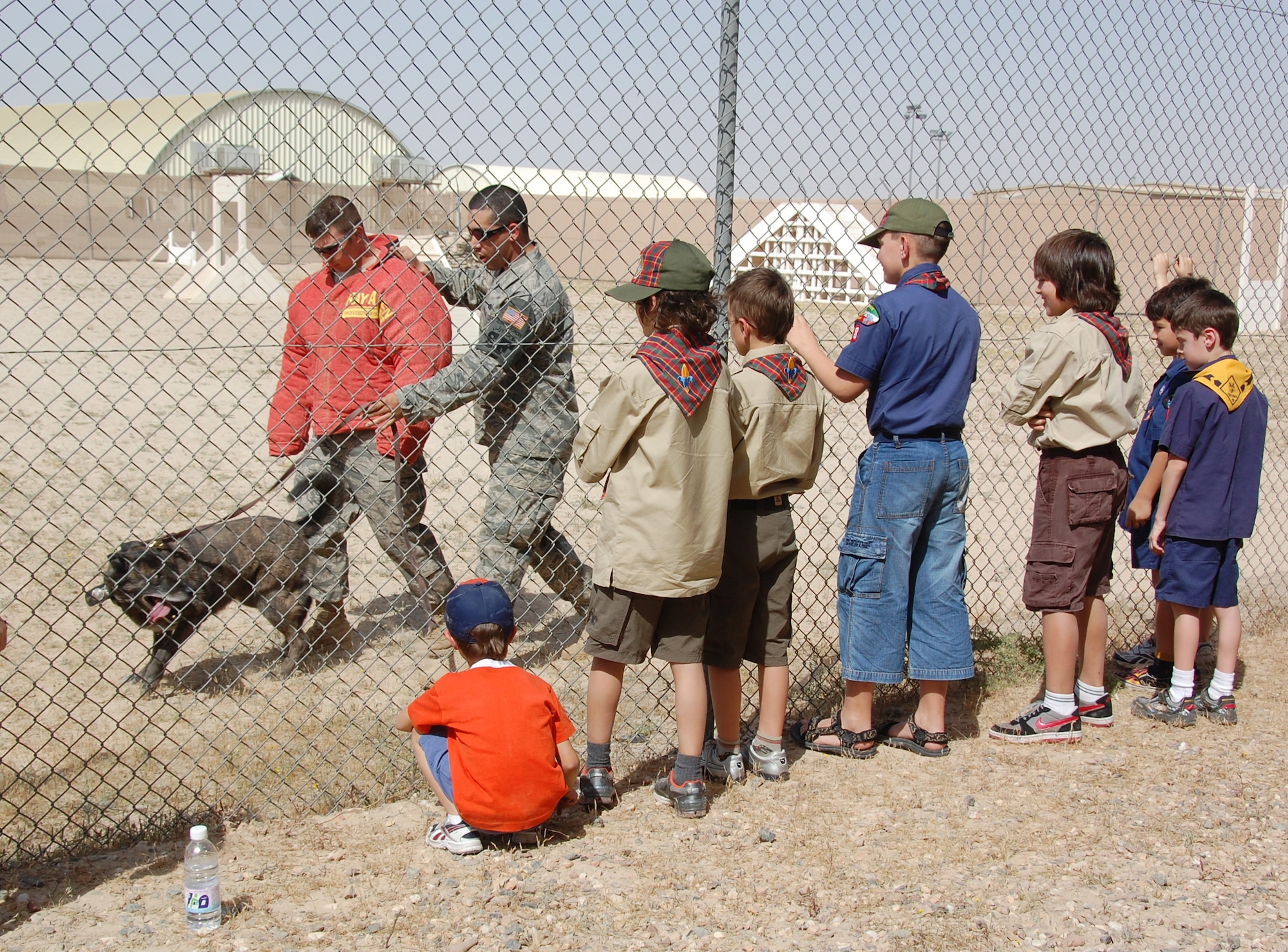 U.S. Air Force Staff Sgt. Steven Rosario, 386th Expeditionary Security Forces Squadron military working dog handler, and his K-9 partner Tay, conduct a demonstration for local Boy Scouts and Cub Scouts March 13, 2010 as part of the Scouts' tour of an air base in Southwest Asia. (U.S. Air Force photo by Staff Sgt. Lindsey Maurice/Released)