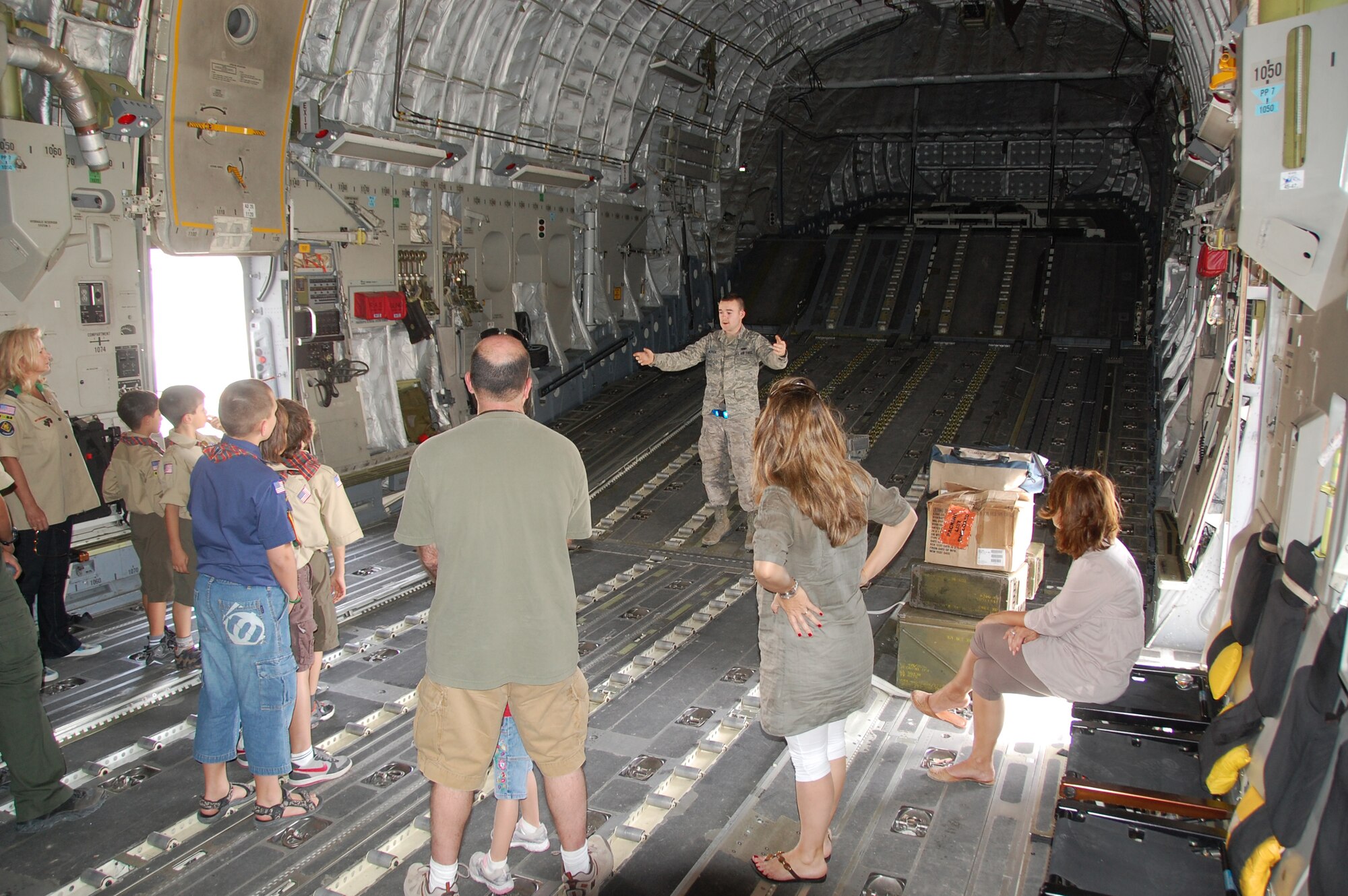 Airman 1st Class Spencer McPeek, 5th Expeditionary Aircraft Maintenance Squadron, talks with local Boys Scouts and Cub Scouts about the C-17 Globemaster March 13, 2010 as part of the Scouts' tour of an air base in Southwest Asia. During the tour, the scouts, who reside near the undisclosed location, visited with EOD, Fire Department and Military Working Dog Airmen; walked through C-130 and C-17 static displays on the flightline and ate lunch at the dining facility. (U.S. Air Force Staff Sgt. Lindsey Maurice/Released)