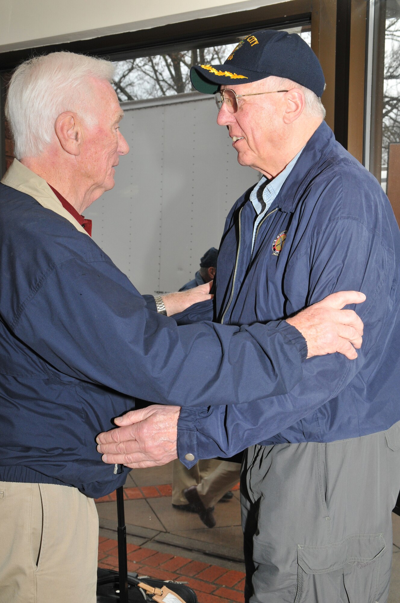 RAF MILDENHALL, England – Astronaut Gene Cernan and former “Good Morning America” host David Hartman embrace outside lodging at RAF Mildenhall March 12 after their participation in the “Legends of Aerospace: The Impossible Is Possible” tour at RAF Mildenhall’s Galaxy Club the previous evening. In addition to Mr. Cernan and Hartman, the tour featured: the first astronaut to walk on the moon Neil Armstrong, Apollo 13 Commander Jim Lovell, last Air Force pilot ace Steve Ritchie, and SR-71 Chief Test Pilot Bob Gilliland. Mr. Cernan was the last astronaut to walk on the moon. (U.S. Air Force photo/Tech. Sgt. Kevin Wallace)