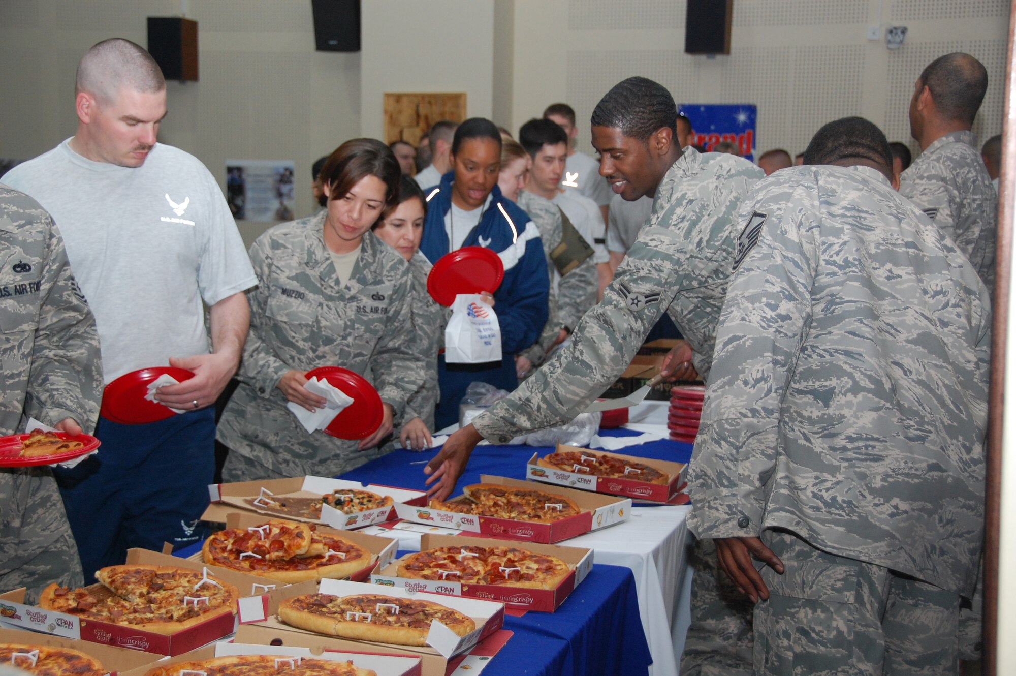 U.S. Air Force Airmen enjoy free pizza during the base theater grand opening celebration here March 12, 2010 at an air base in Southwest Asia. (U.S. Air Force photo by Staff Sgt. Lindsey Maurice/Released)