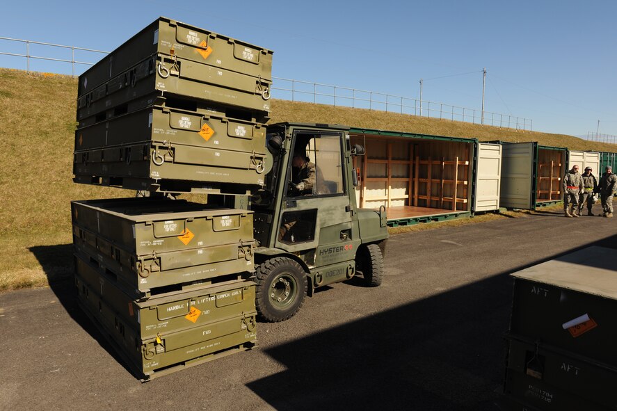 RAF WELFORD, United Kingdom - Crew members with the 420th Munitions Squadron carry out munitions from a storage area to place them in a container March 8. The squadron is preparing to ship more than 800 tons of explosives and equipment in mid May. (U.S. Air Force photo by Tech. Sgt. John Barton) 