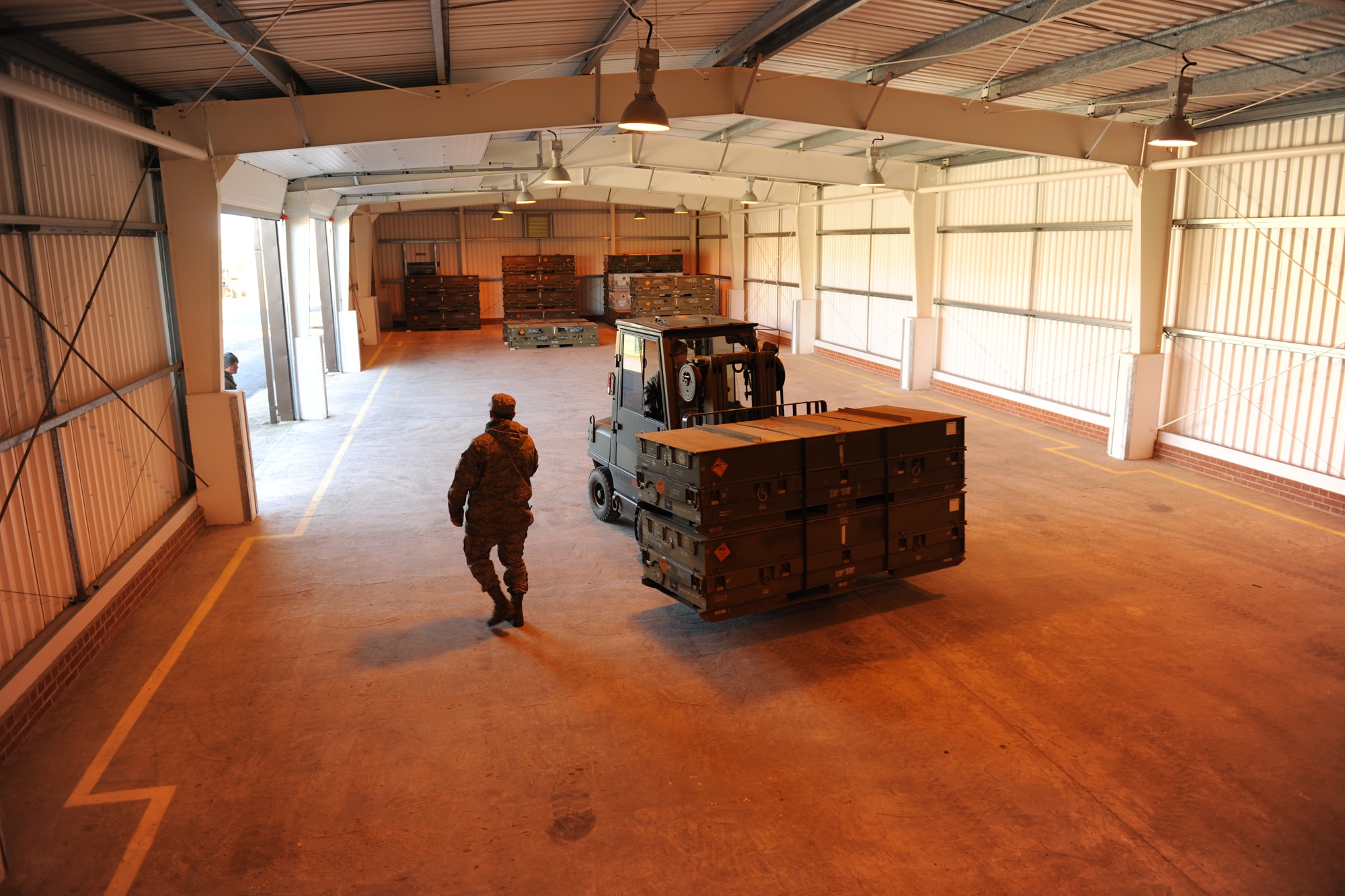 RAF WELFORD, United Kingdom - Crew members with the 420th Munitions Squadron carry out munitions from a storage area to place them in a container March 8. The squadron is preparing to ship more than 800 tons of explosives and equipment in mid May. (U.S. Air Force photo by Tech. Sgt. John Barton)