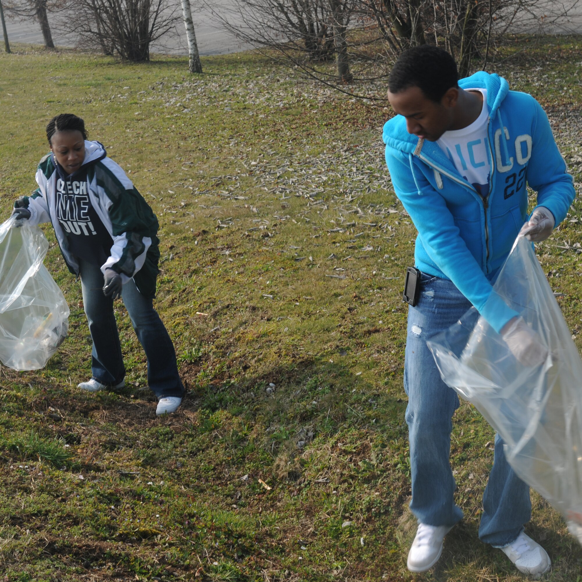 Senior Airman Shaun Haynes and Tech. Sgt. Sonya Braxton, 31st Force Support Squadron, pick up trash March 15 at the industrial area of Aviano, during Ecological day. More than 170 Aviano Airman and civilians teamed up with members of local Aviano Community to cleanse Aviano streets of trash and debris.(U.S. Air Force photo/Airman LaVel Sterling)
