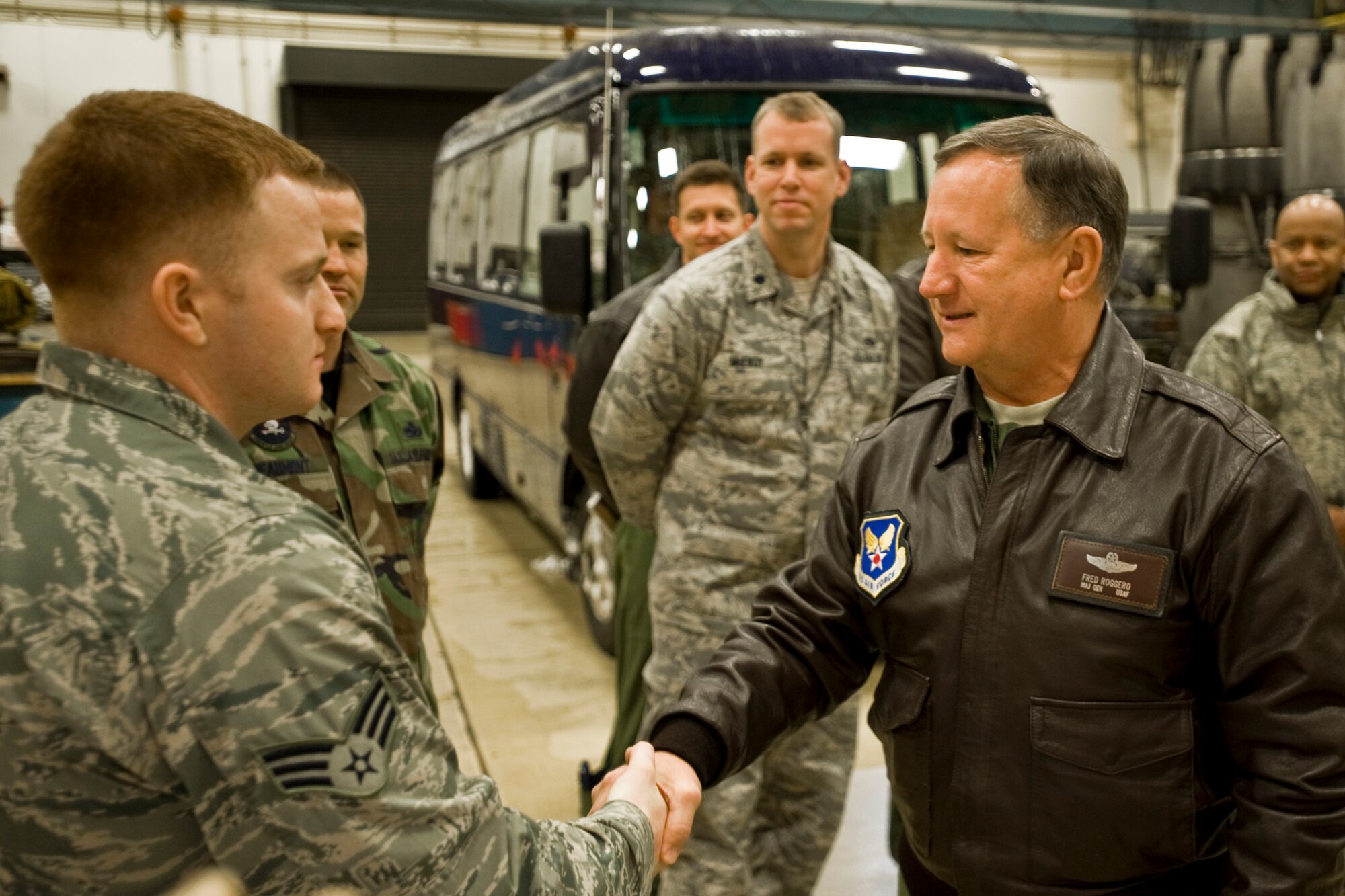 MISAWA AIR BASE, Japan -- Maj. Gen Federick Roggero, Air Force Chief of Safety, shakes hands with Senior Airman Justin Thomas, 35th Maintenance Squadron aerospace propulsion journeyman, March 10 at the 35th MXS propulsion shop. Airman Thomas briefed General Roggero on the propulsion flight's mission. (U.S. Air Force photo/Senior Airman Jamal D. Sutter)