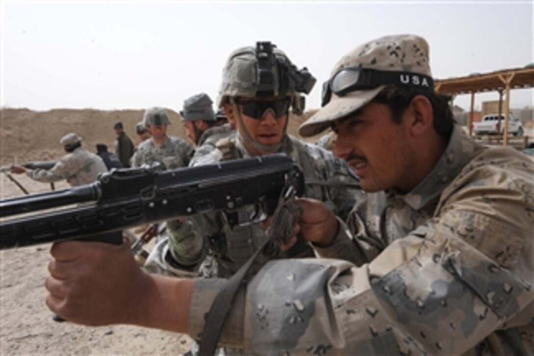 U.S. Army Sgt. Curtis Webb, with Bear Troop, 8th Squadron, 1st Cavalry Regiment, conducts basic marksmanship refresher training with an Afghan Border Policeman at Forward Operating Base Spin Boldak, Afghanistan, on Feb. 28, 2010.  