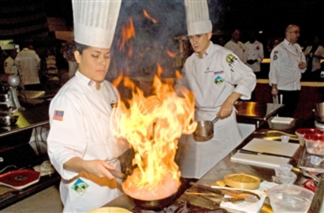 U.S. Army Pvt. Danielle Cassinacabrera and Cpl. Jason Daniels compete in the Junior Chef competition during the 35th Culinary Arts Competition at Fort Lee, Va., on March 4, 2010.  