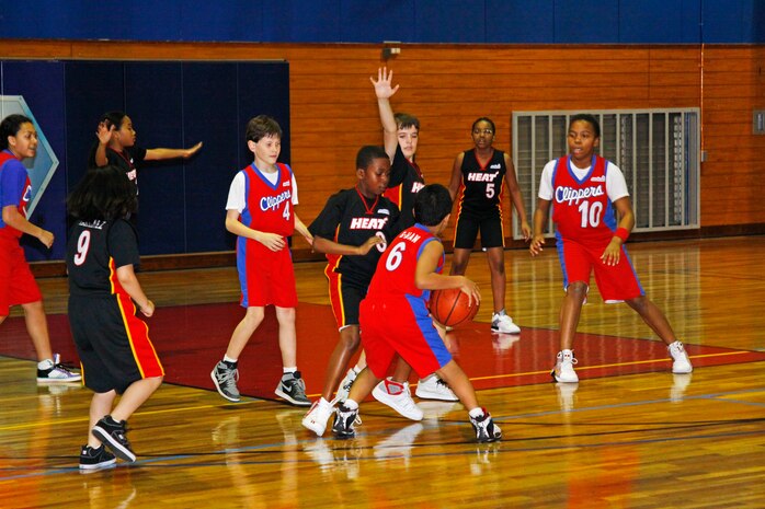 A player from the Clippers looks for an open teammate to pass and set up a shot during a youth basketball game at the IronWorks Gym here March 6. A total of 32 teams are ready for action with three cheer squads ready to cheer them on this season.