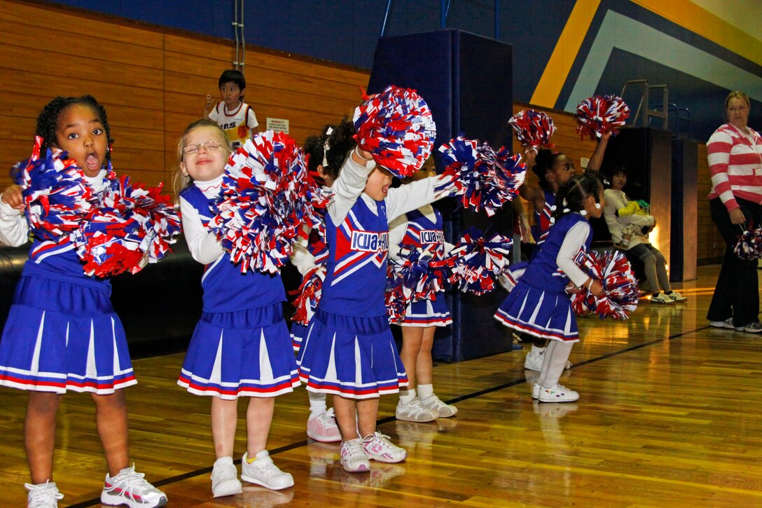 Cheerleaders encourage the youth basketball players by singing and chanting at the IronWorks Gym here March 6. A total of three cheer squads are on the courts this season boosting players, parents, and other spectators.