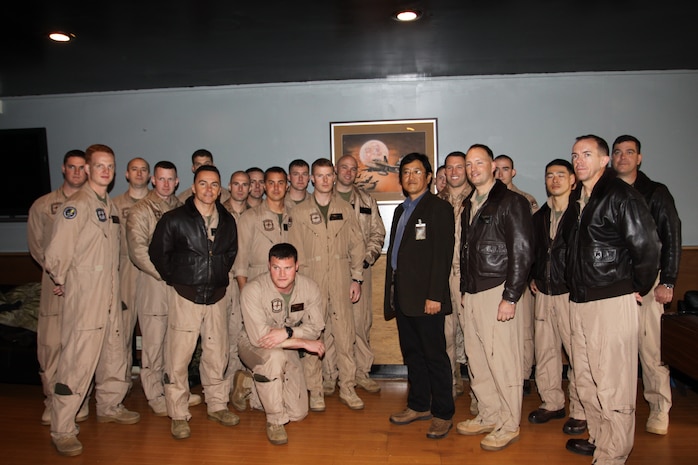 Marine All-Weather Fighter Attack Squadron 242 recieves an original piece of art by Satoshi Watanabe, a Japanese painter, here March 15. The work of art is a night scene of a 242 F/A-18 Hornet flying in front of a full moon with a stream of bats flying around the aircraft.