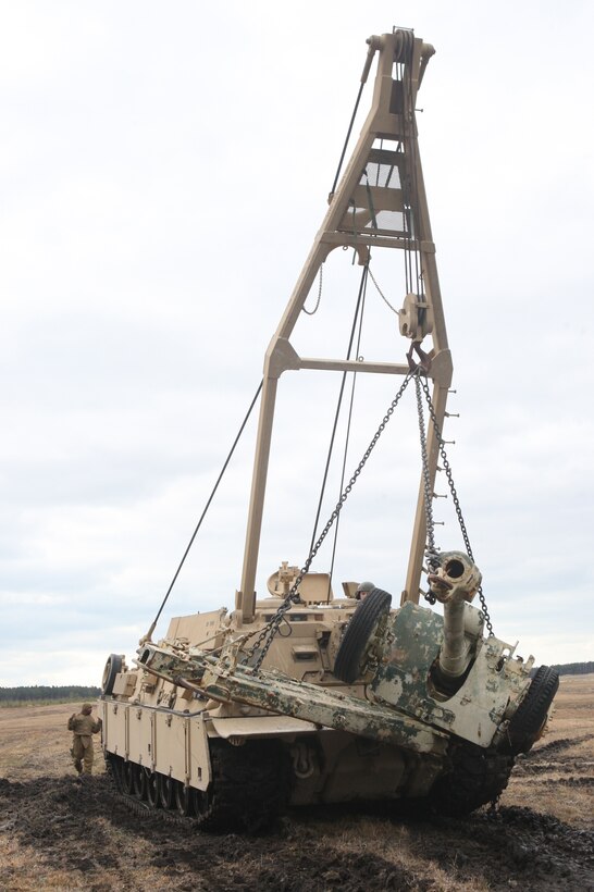 An M88 Hercules recovery vehicle from Company C, 2nd Tank Battalion, 2nd Marine Division moves an abandoned Soviet 122mm howitzer D-30 during its recovery operation, March 16. Discovered by retired Col. Terry Cahill two years ago, the howitzer will be refurbished and donated to a local organization as an Iraqi War memorial.