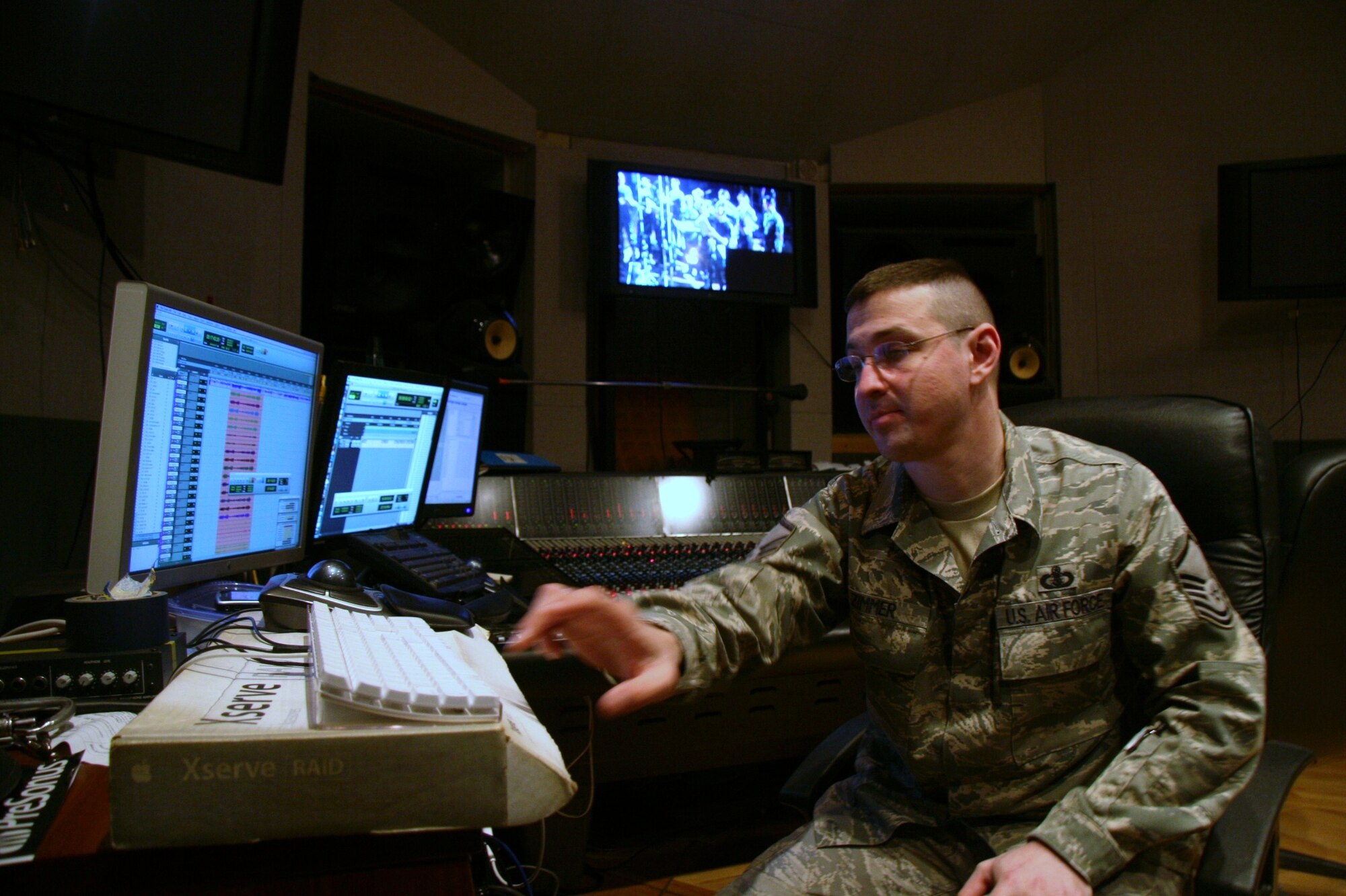 Master Sgt. Loren Zimmer, an audio engineer for The USAF Band, works in the control room, preparing for the next take.  He is recording the Singing Sergeants for The United States Air Force Band's upcoming compact disc (CD), "Off We Go," intended for wide release in December.  (USAF Photo by Benjamin Newell)
