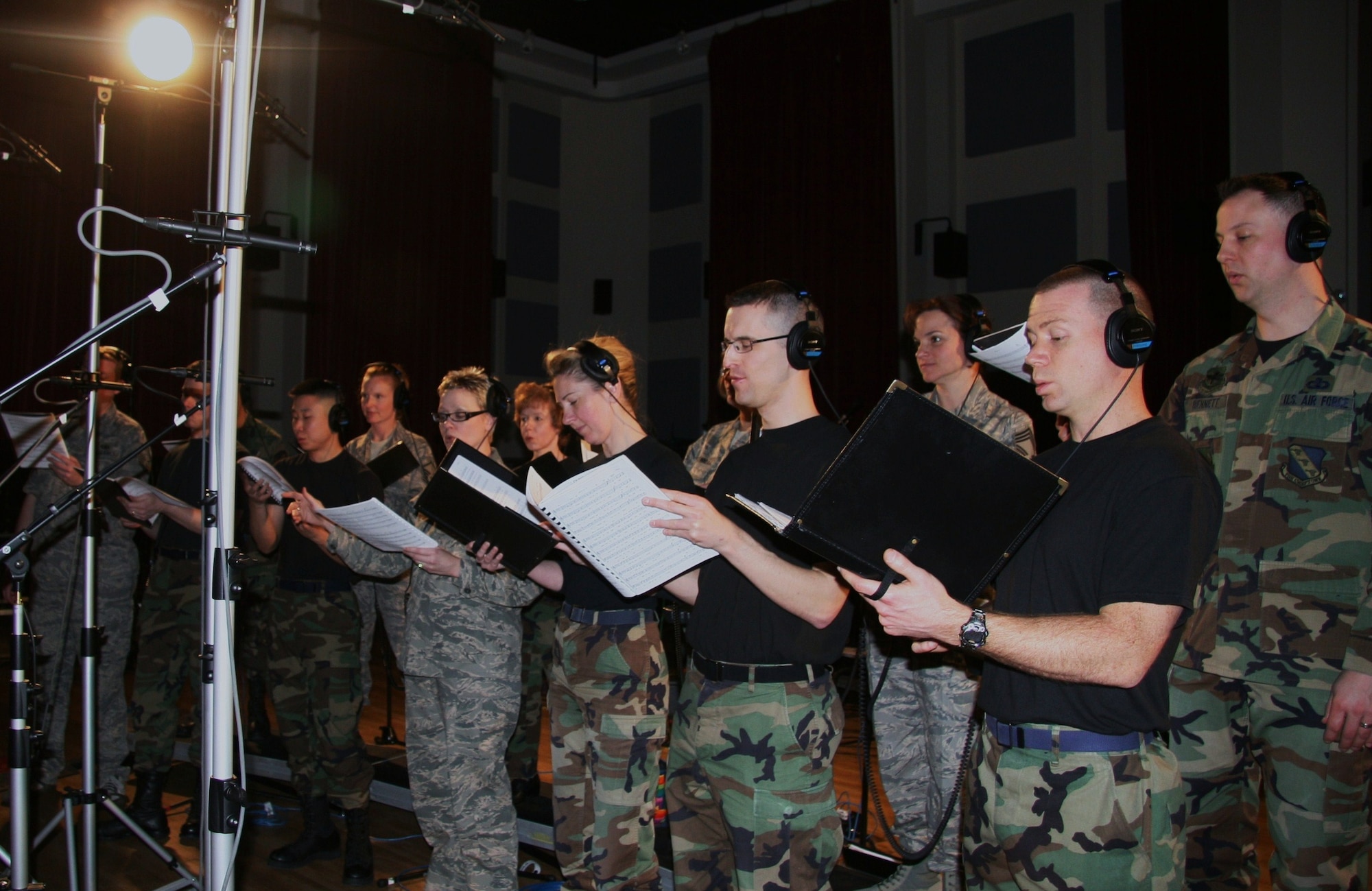 The Singing Sergeants perform a take of "Off We Go," by Chief Master Sgt. (ret.) Mike Davis in Hangar II on Bolling AFB, Washington, D.C.  They are recording for The United States Air Force Band's upcoming compact disc (CD), "Off We Go," intended for wide release in December.  (USAF Photo by Benjamin Newell)
