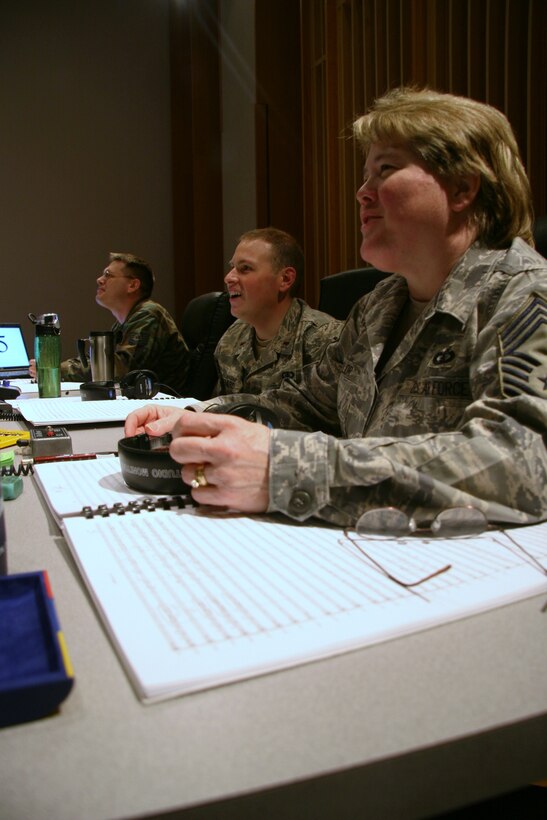 Chief Master Sgt. Barbara Taylor, 2nd Lieutenant Peter Folliard, and Technical Sgt. James DeVaughn enjoying a light moment while working hard behind the scenes.  They are working to produce The United States Air Force Band's upcoming compact disc (CD), "Off We Go," intended for wide release in December.  (USAF Photo by Benjamin Newell)