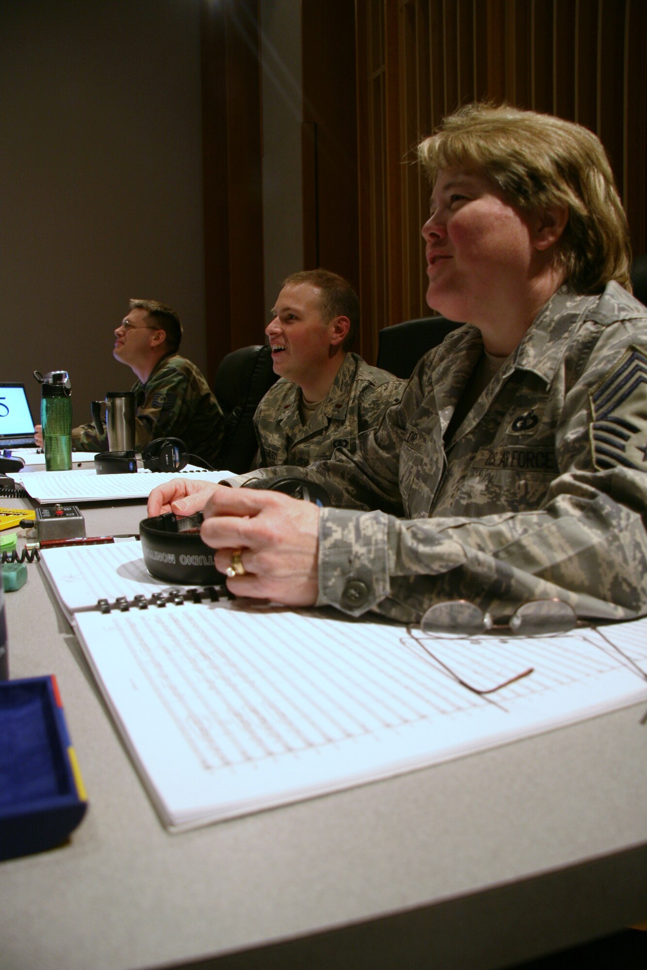 Chief Master Sgt. Barbara Taylor, 2nd Lieutenant Peter Folliard, and Technical Sgt. James DeVaughn enjoying a light moment while working hard behind the scenes.  They are working to produce The United States Air Force Band's upcoming compact disc (CD), "Off We Go," intended for wide release in December.  (USAF Photo by Benjamin Newell)