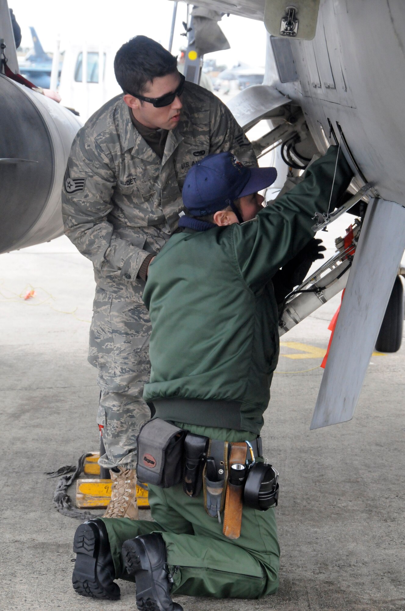 TSUIKI AIR BASE, Japan -- Staff Sgt. Christopher Audet, 35th Aircraft Maintenance Squadron crewchief, watches as Japan Air Self-Defense Force Senior Airman Naoki Yamashita conducts post-flight checks on the F-16 Fighting Falcon March 11. The two crewchiefs spent a week working with each other as part of a cross-familiarization program. (U.S. Air Force photo/Staff Sgt. Rachel Martinez) 