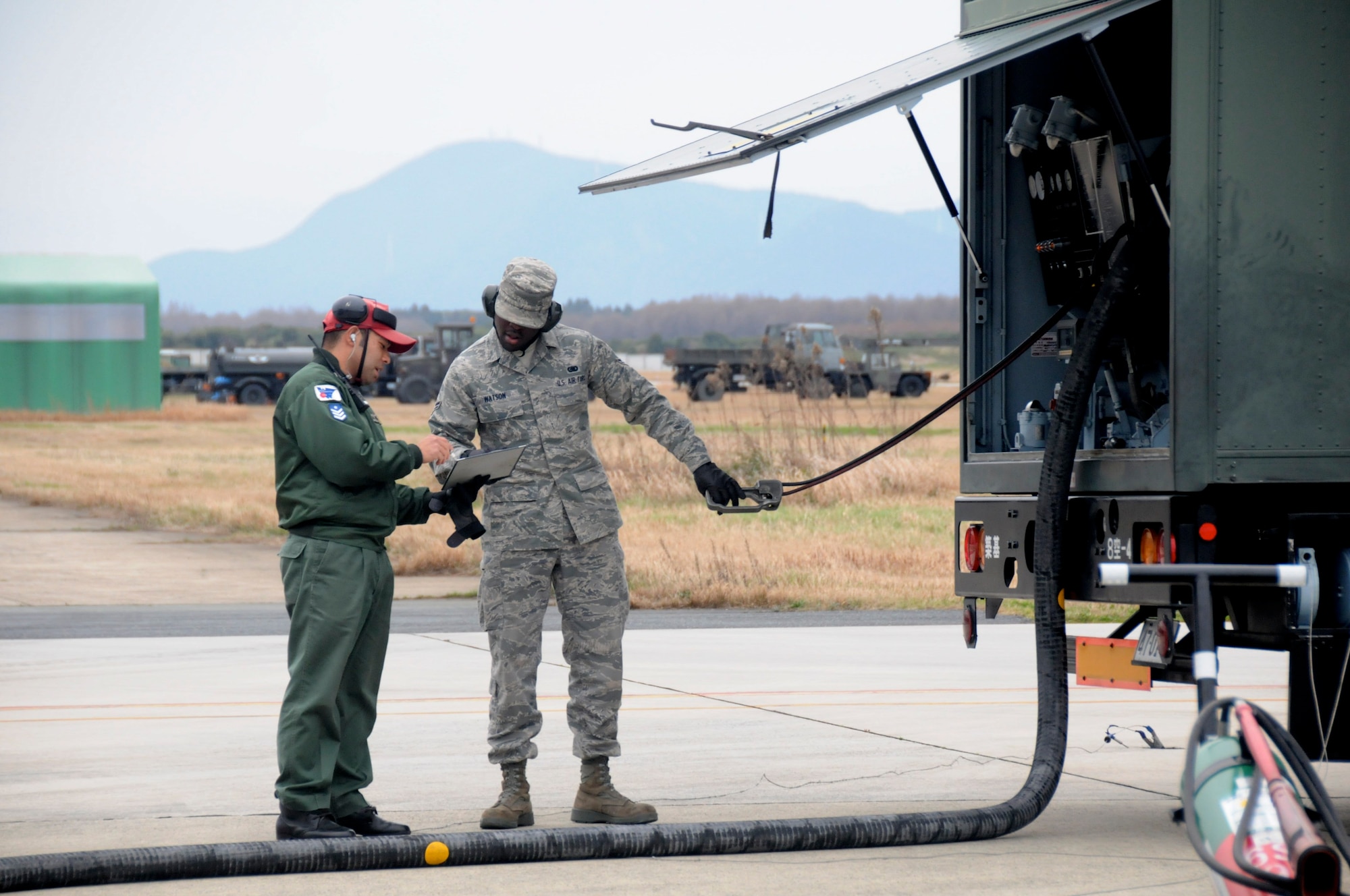 TSUIKI AIR BASE, Japan -- Airman 1st Class Curtis Watson, 35th Logistics Readiness Squadron fuels specialist, takes notes from a Japan Air Self-Defense Force airman while refueling an aircraft during an aviation training relocation exercise March 8. Airman Watson was one of two fuels Airmen to participate in a cross-familiarization program during the weeklong ATR. (U.S. Air Force photo/Staff Sgt. Rachel Martinez)