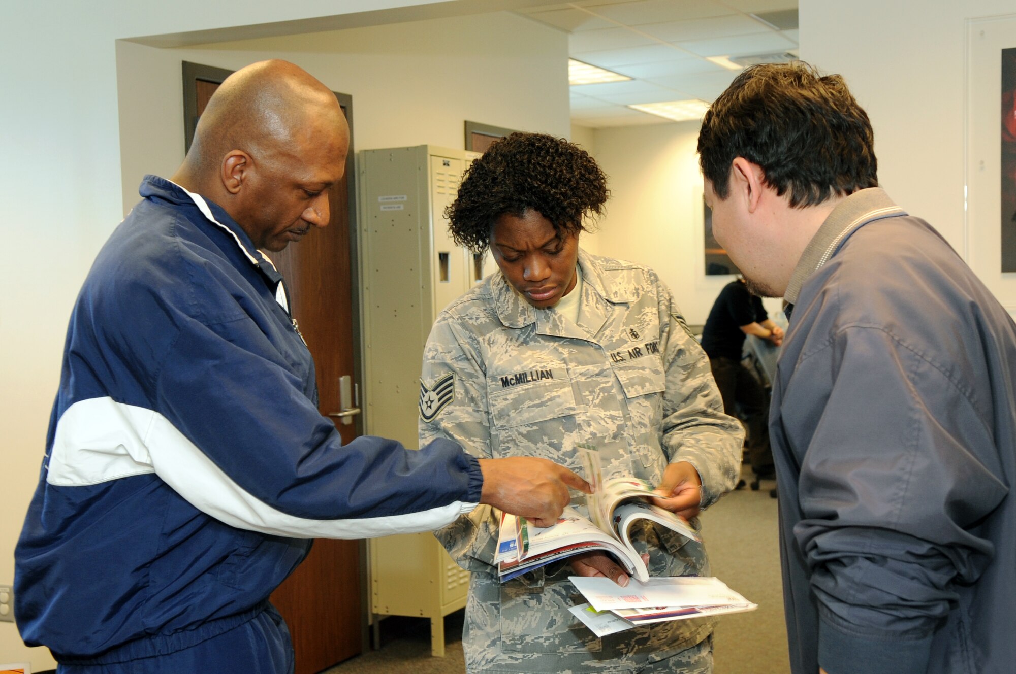 BUCKLEY AIR FORCE BASE, Colo. -- Tech. Sgt. Jamie Cole, Staff Sgt. Miracle McMillian and David Warfield review patient information March 16 at the 460th Medical Group Physical Therapy Clinic. Sergeant McMillian and Mr. Warfield help rehabilitate injured members of Team Buckley. ( U.S. Photo by Airman 1st Class Marcy Glass )