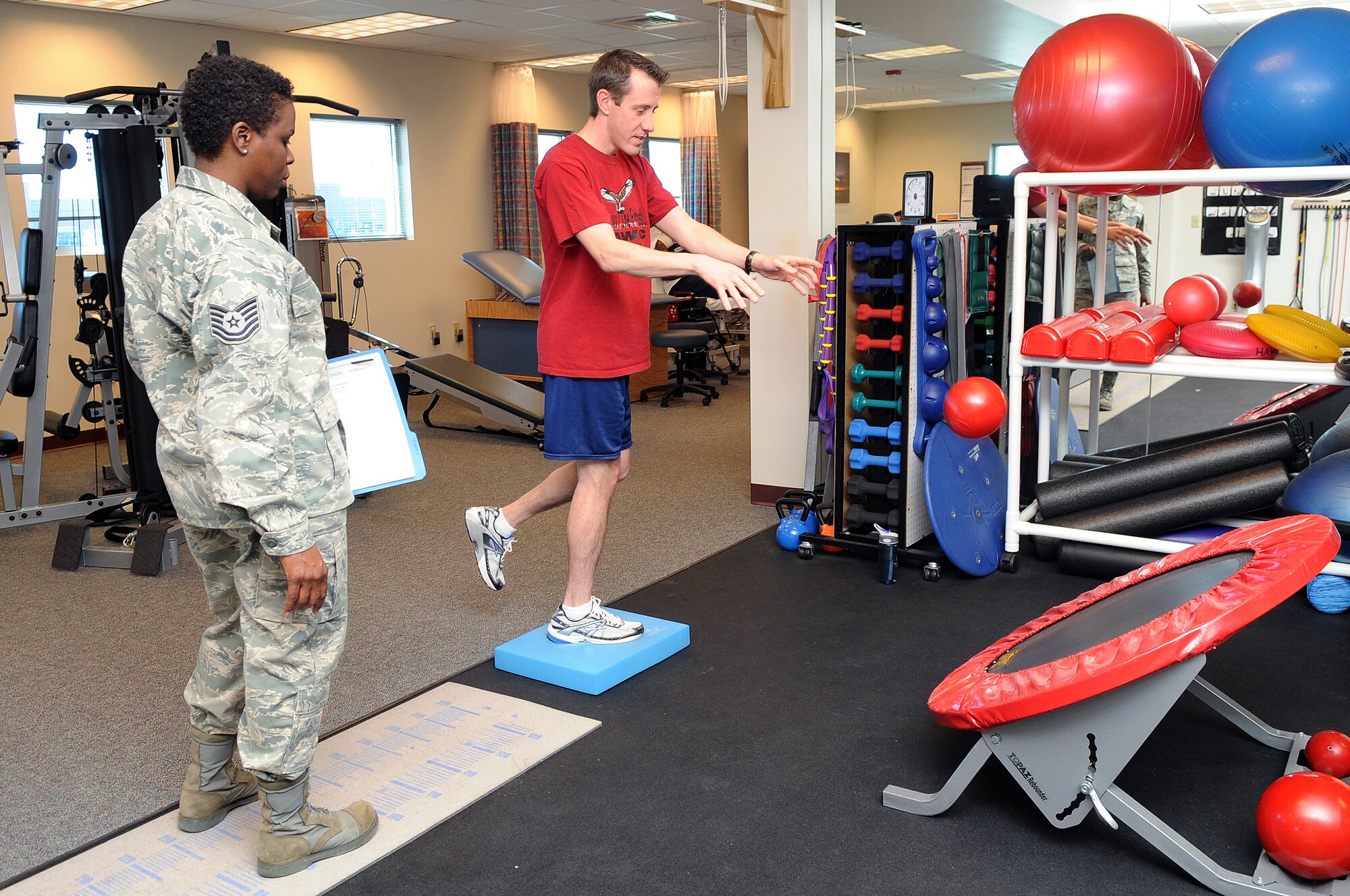 BUCKLEY AIR FORCE BASE, Colo. -- Tech. Sgt. Jacqueline Davis observes Master Sgt. David Seratte perform his physical therapy March 16.  ( U.S. Photo by Airman 1st Class Marcy Glass )