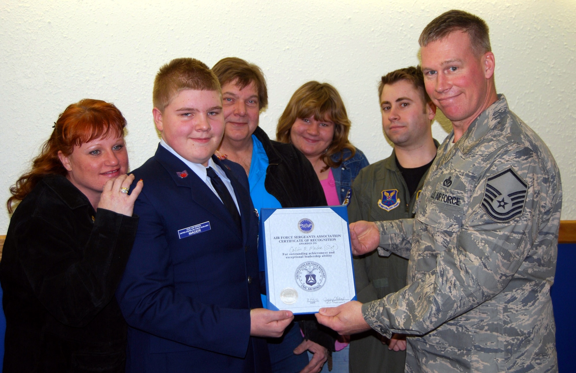 Master Sgt. William Gamradt, Air Force Sergeants Association vice president, awarded Cadet Staff Sgt. Calvin Mader, Civil Air Patrol, the Cadet NCO of the year award among family and friends during an AFSA meeting Feb. 24. Cadet Mader recieved the award for his dedication, leadership  and enthusiasm as a member and his long string of accomplishments to inlcude completing programs and assisting his Squaadron in winning awards such as the Aerospace Excellence Award. (U.S. Air Force photo/Airman 1st Class Kristina Overton)