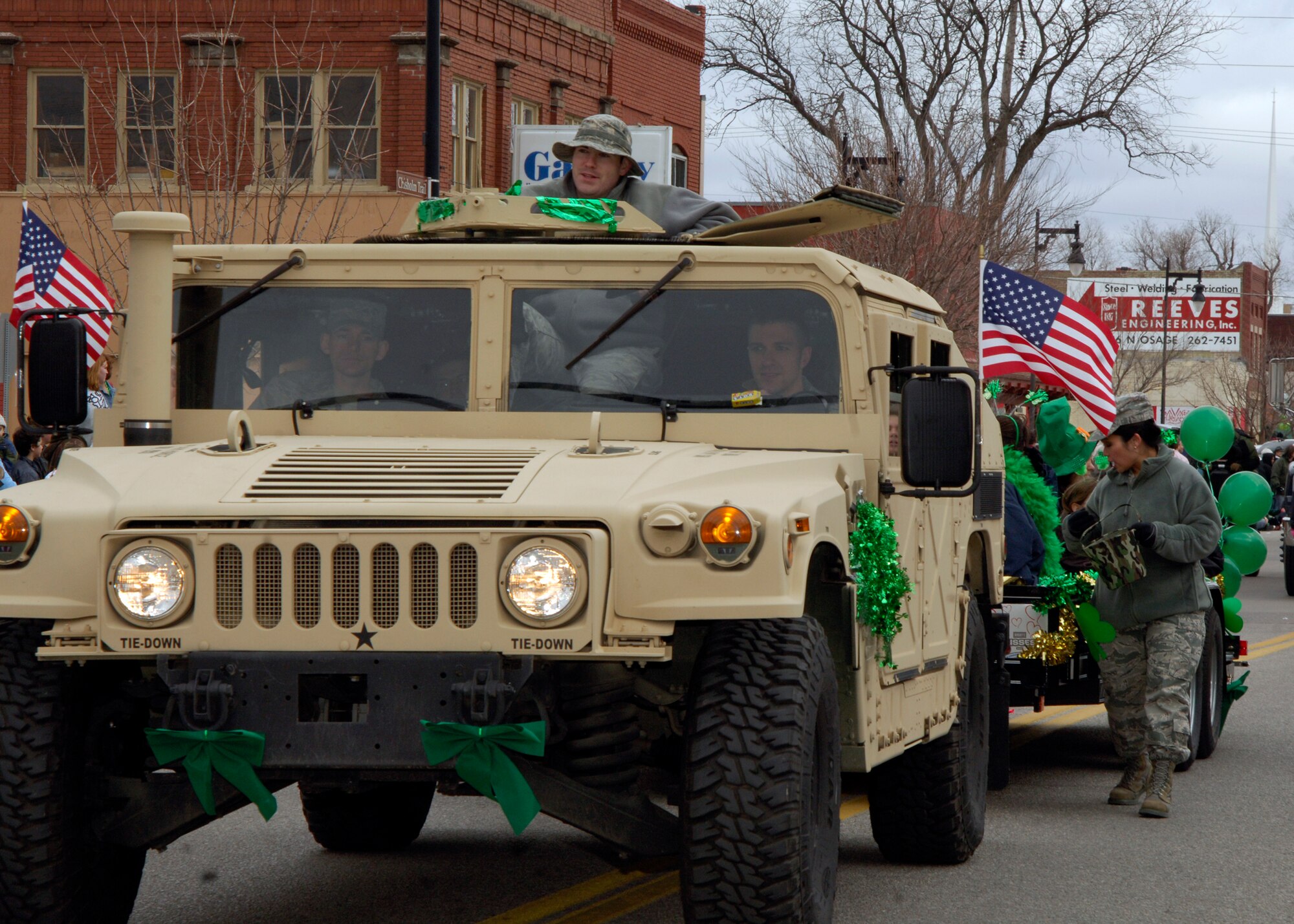 An Air Force Humvee pulls a float carrying families of deployed Airmen during the fourth annual St. Patrick’s Day Parade held in downtown Wichita, Kan., March  13, 2010. McConnell’s float was decorated by the students and members of the Airman Leadership School. The Airmen at McConnell support the base’s mission which is to operate and maintain the world’s largest and most diverse KC-135 Stratotanker fleet. (U.S. Air Force photo / Airman 1st Class Andrea Salazar)