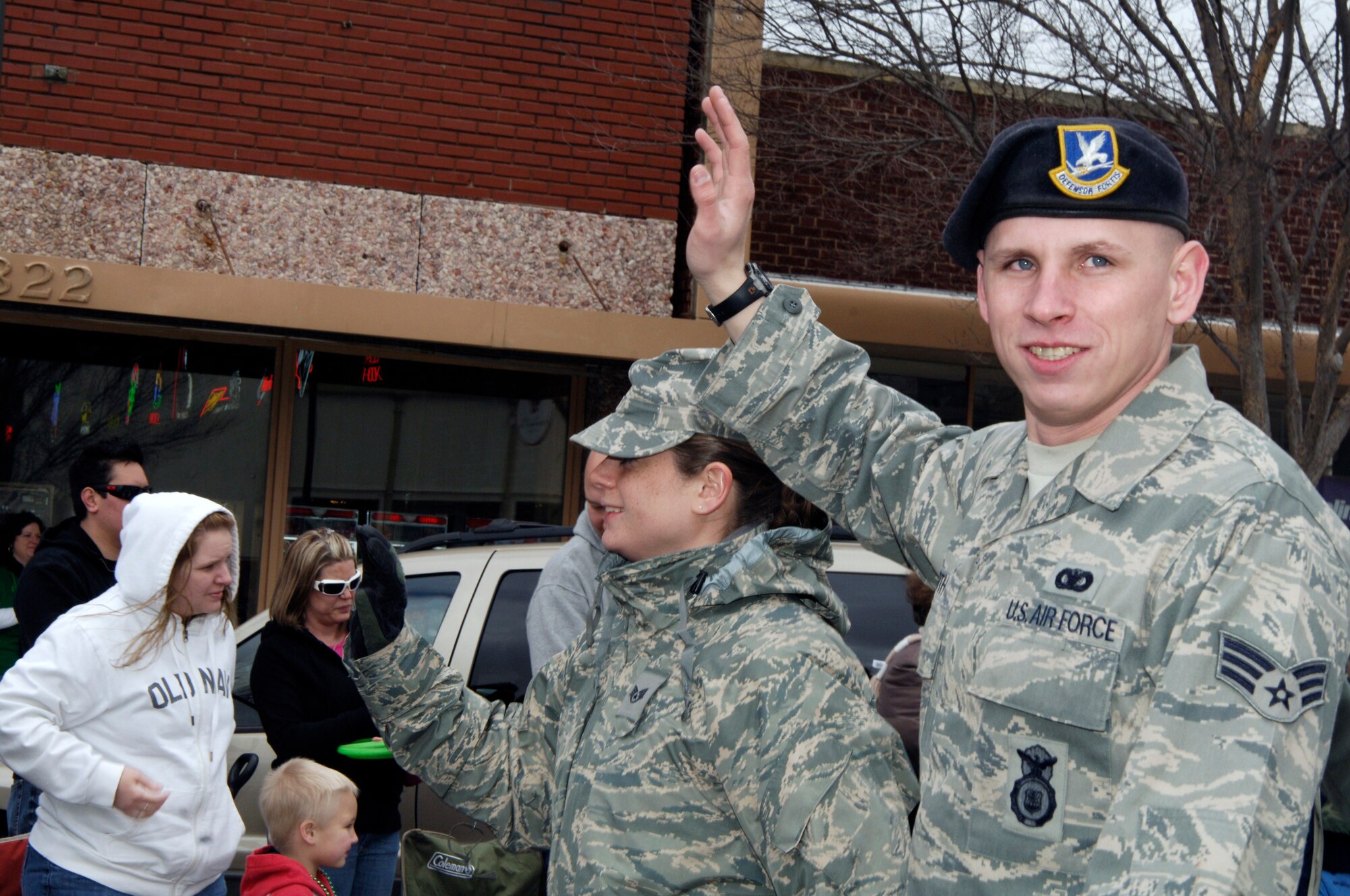 Team McConnell Airmen wave to spectators during a St. Patrick’s Day Parade held in downtown Wichita, Kan., March  13, 2010. More than 50 Team McConnell members participated in the fourth annual parade. Airmen from a variety of career fields such as public affairs, explosive ordnance disposal, chaplains, security forces, firefighters and many others represented the Air Force in the parade. (U.S. Air Force photo / Airman 1st Class Andrea Salazar)