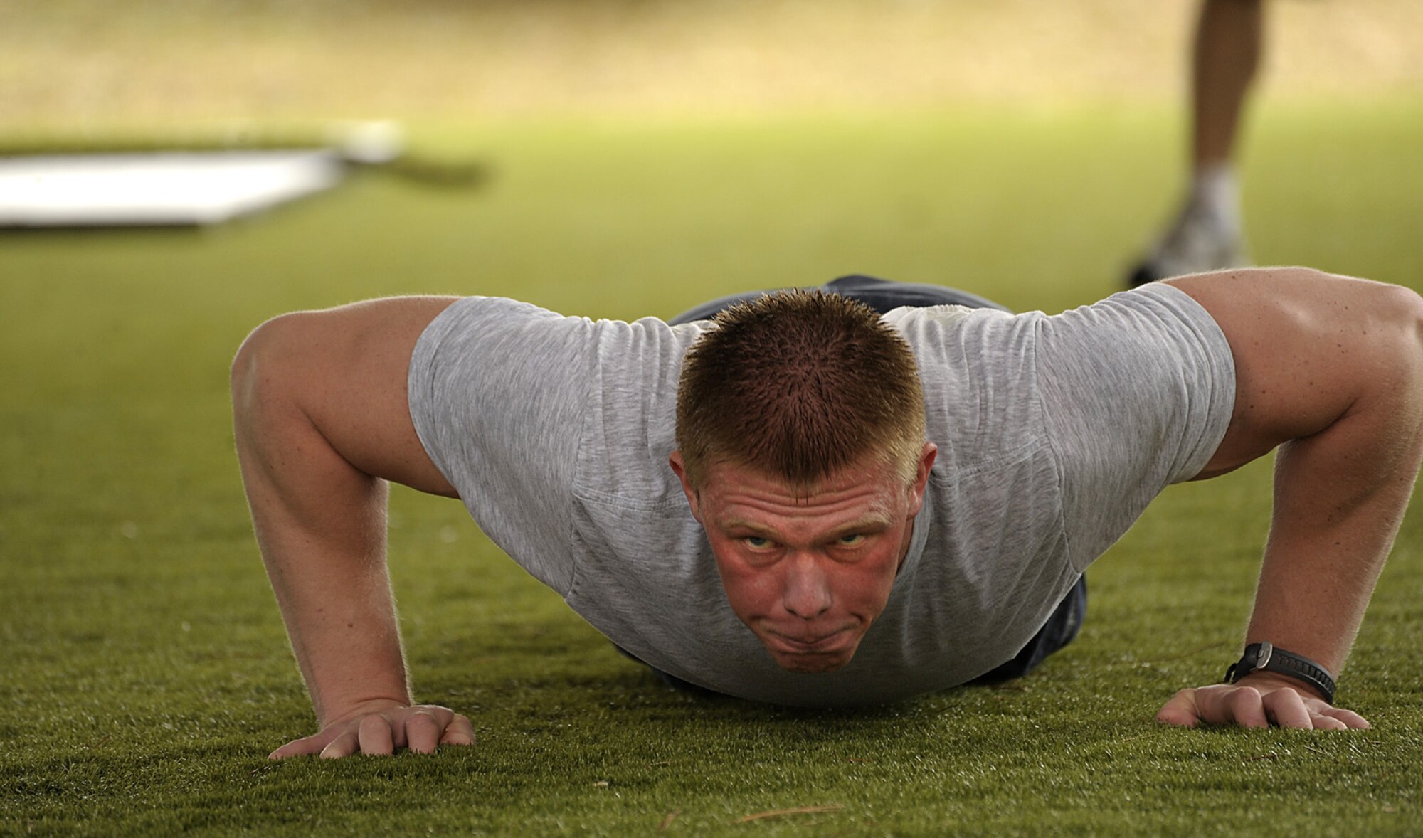 Senior Airman Matthew Sattler, 4th Aircraft Maintenance Unit, performs push-ups during the Physical Ability Stamina Test held March 12 at Hurlburt Field, Fla.  Hosted by the Air Force Special Operations Training Center, candidates had to pass every element of the PAST to qualify for combat control, pararescue, special operations weather or the combat rescue officer career fields.  (U.S. Air Force photo by Master Sgt. Russell E. Cooley IV) (Released)