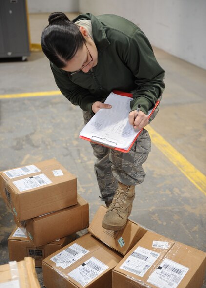 DYESS AIR FORCE BASE, Texas — Airman 1st Class Laura Jimenez, 7th Logistics Readiness Squadron, checks inbound cargo March 16 at the traffic management warehouse here. All inbound cargo must be checked and matched with paperwork before it can be turned over to supply. (U.S. Air Force photo/ Airman 1st Class Brittney Prescott)