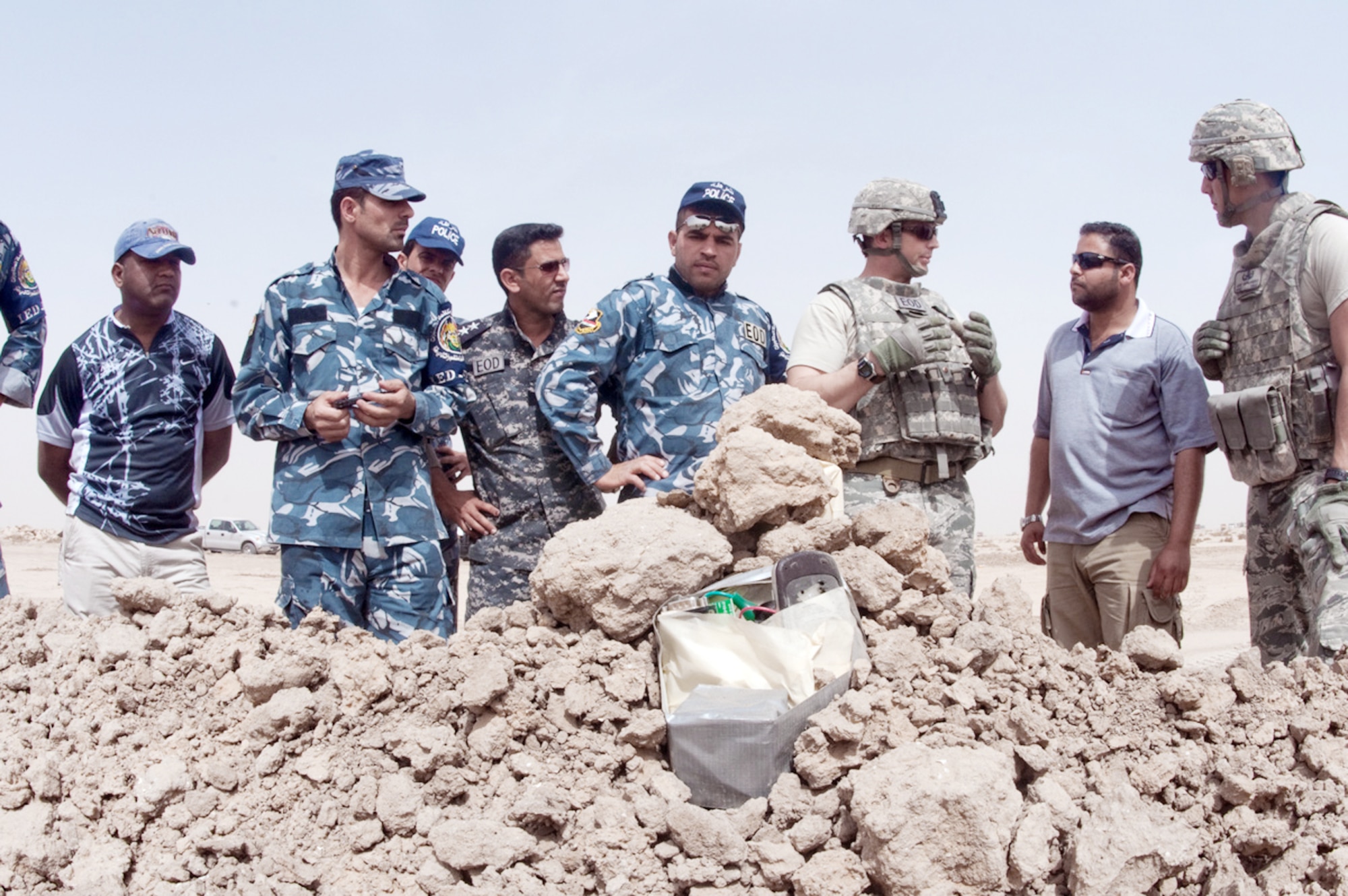 Tech Sgt. William Adomeit explains the procedures on how to disable an improvised explosive device to members of the Dhi Qar Province explosive ordnance police team March 11, 2010, at Ali Base, Iraq. Sergeant  Adomeit is a 407th Explosive Ordnance Disposal team member deployed from Luke AFB, Ariz. (U.S. Air Force photo by Senior Master Sgt. Elizabeth Gilbert)
