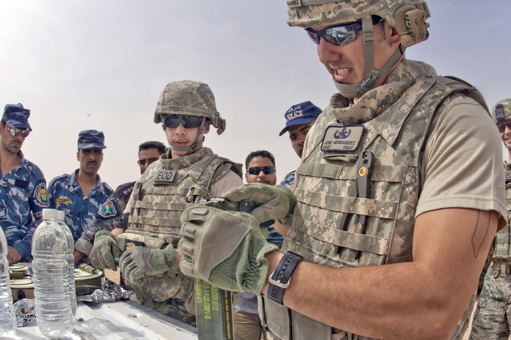Tech. Sgt. Joe Hernandez and Airman 1st Class Stephen Alvarez demonstrate the use of C4 explosives in the construction of a water charge designed to disable an improvised explosive device to members of the Dhi Qar Province explosive ordnance police team March 11, 2010, at Ali Base, Iraq. Sergeant Hernandez and Airman Alvarez are on the 407th Air Expeditionary Group Explosive Ordnance Disposal team deployed from Luke AFB, Ariz. (U.S. Air Force photo by Senior Master Sgt. Elizabeth Gilbert)