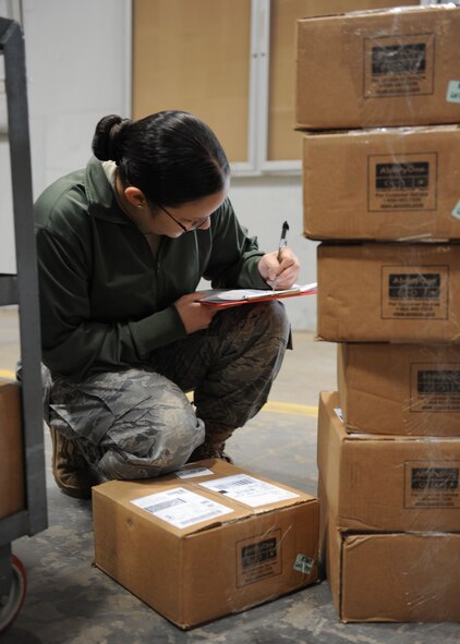 DYESS AIR FORCE BASE, Texas—Airman 1st Class Laura Jimenez, 7th Logistics Readiness Squadron, checks inbound cargo March 16 at the traffic management warehouse here. All inbound cargo must be checked and matched with paperwork before it can be turned over to supply. (U.S. Air Force photo/ Airman 1st Class Brittney Prescott)