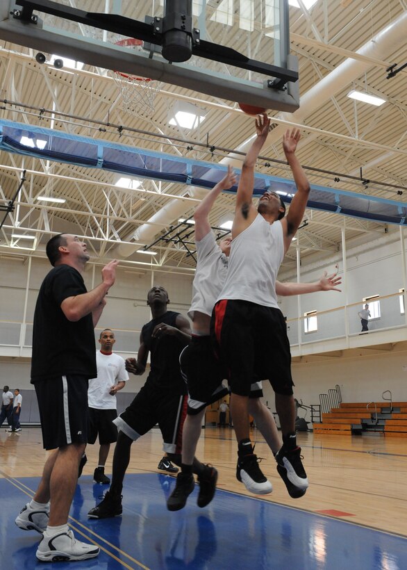 DYESS AIR FORCE BASE, Texas – Dyess Airmen play basketball March 12 at the Dyess fitness center here. The Dyess fitness center hosted a 3-on-3 basketball tournament consisting of 3 teams that competed with each other in several 10 minute games. (U.S. Air Force photo/ Airman 1st Class Brittney Prescott)
