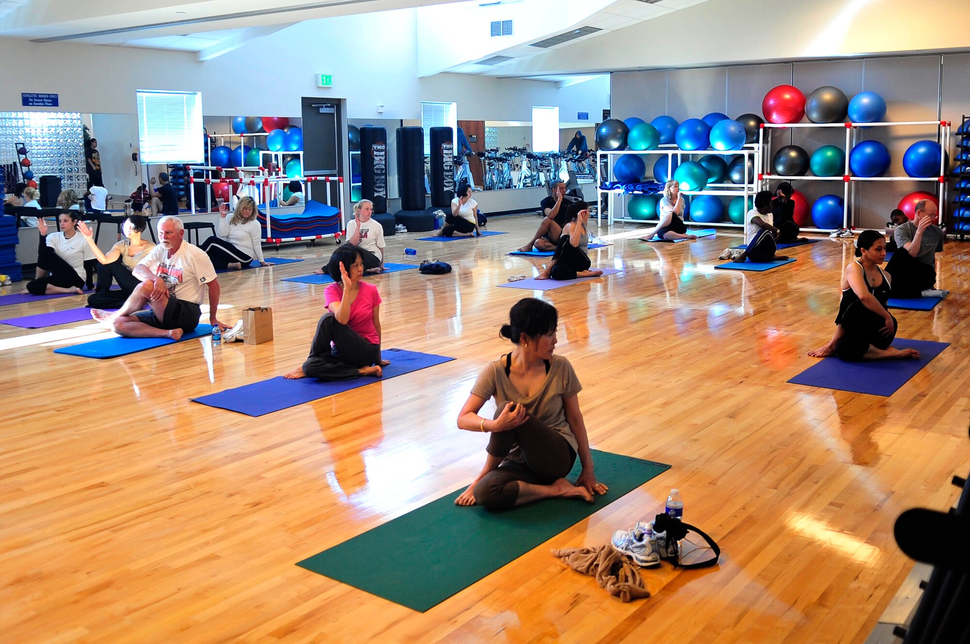 BUCKLEY AIR FORCE BASE, Colo. -- Members of Team Buckley relax and cool down in the Fit Factor Family event yoga class at the Buckley Fitness Center March 13. (U.S. Air Force photo by Airman 1st Class Manisha Vasquez)