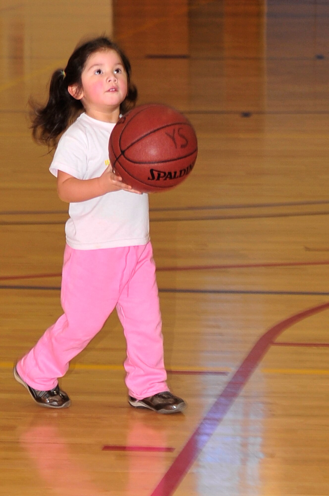BUCKLEY AIR FORCE BASE, Colo. -- Veronica Estrada, daughter of Senior Master Sgt. Gabriel Estrada, plays basketball during the Fit Factor Family event at the Buckley Fitness Center March 13. (U.S. Air Force photo by Airman 1st Class Manisha Vasquez)