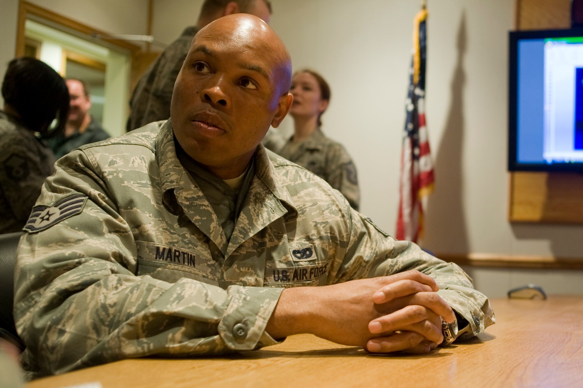 Staff Sgt. Dewayne Martin, 56th Aerial Port Squadron Airman, reflects on his two-week training during a briefing with 62nd Aerial Port Squadron leadership March 11. (U.S. Air Force photo/Abner Guzman)