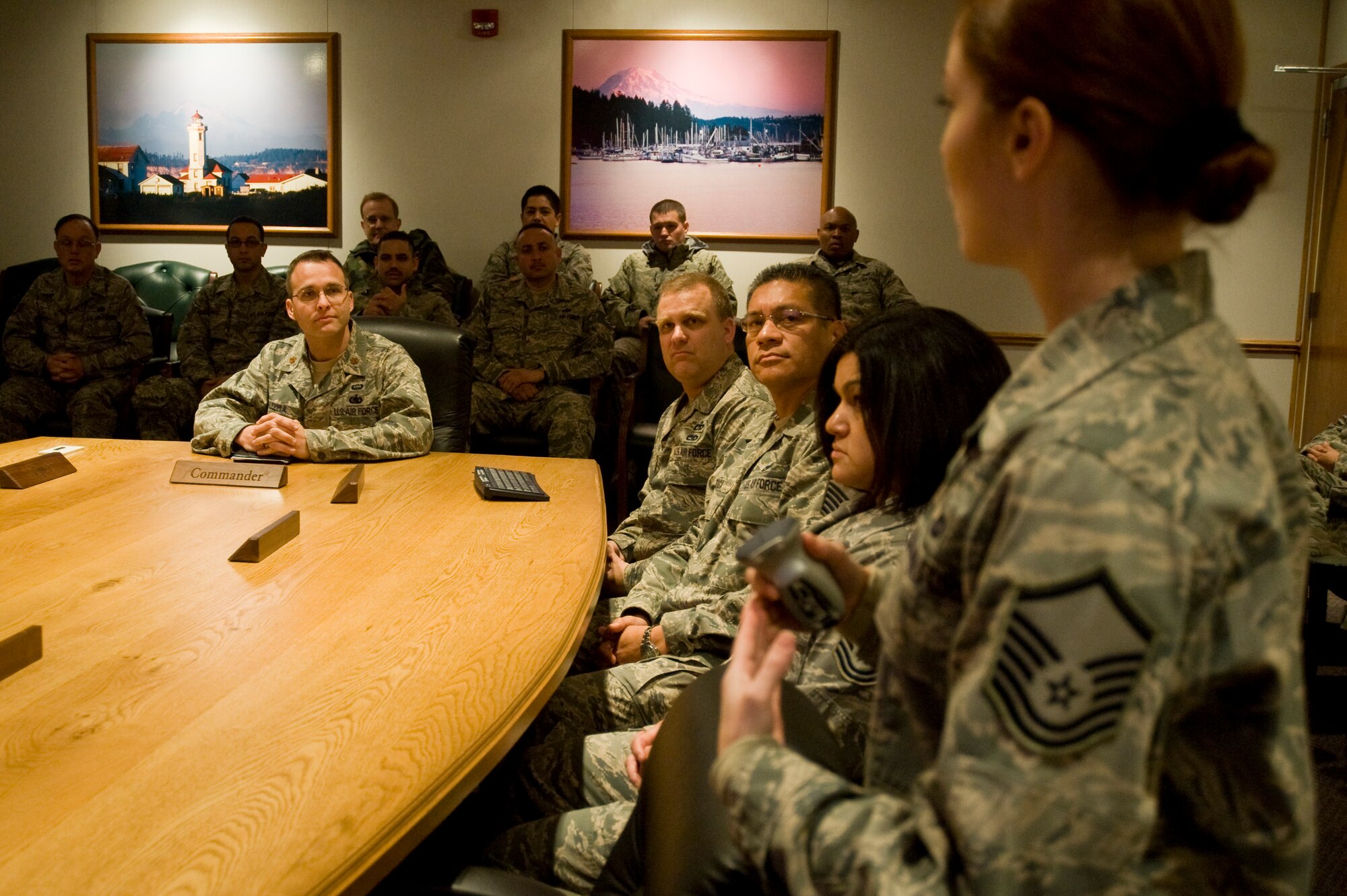 Maj. Gregory Kuzma, 62nd Aerial Port Squadron deputy commander, listens as Master Sgt. Sarah Kraft, 56th Aerial Port Squadron team chief, discusses the experience the Reserve Airmen had and what training they received in a briefing with 62nd Aerial Port Squadron leadership March 11. (U.S. Air Force photo/Abner Guzman)