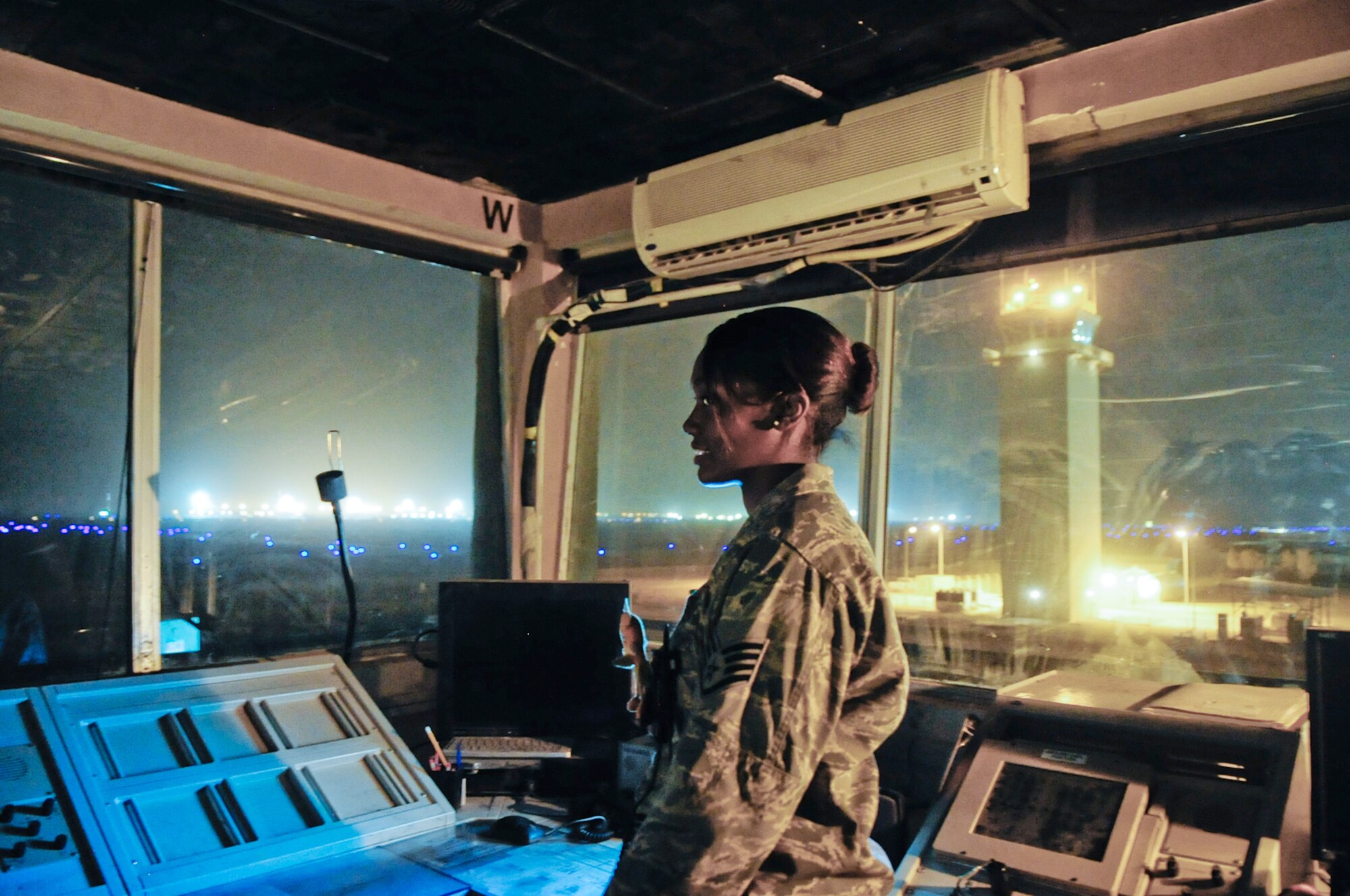 Staff Sgt. Madonna Moffatte sends her last transmission from the old tower as the new air traffic control tower in the background becomes operational March 12, 2010, at Ali Base, Iraq. Sergeant Moffatte is an air traffic controller from the 407 Expeditionary Operations Support Squadron, deployed from 35th Operational Support Squadron, Davis Mothen, Ariz. (U.S. Air Force Photo by Senior Master Sgt. Elizabeth Gilbert)
