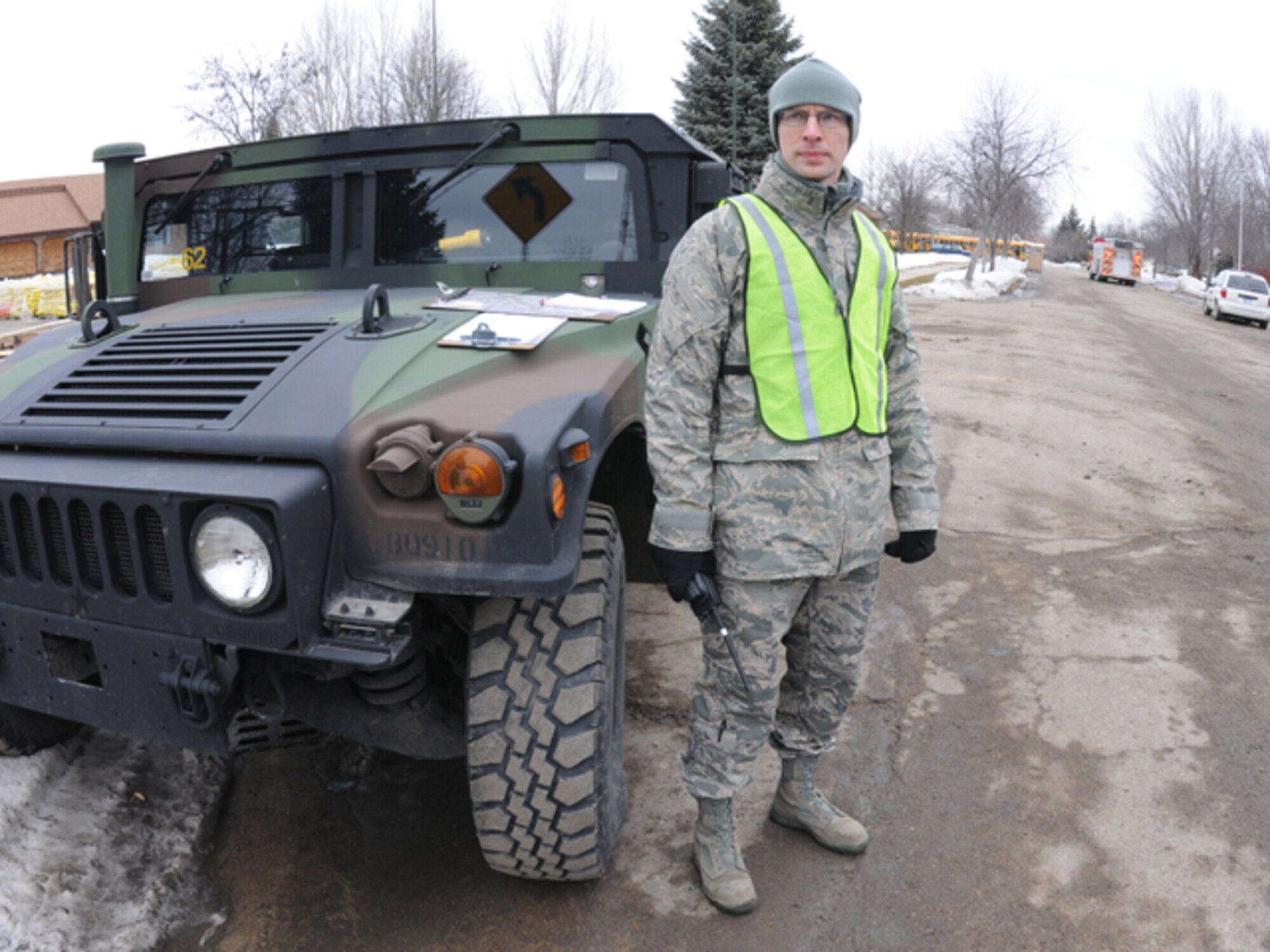 Senior Airman Greg Byer, of the 119th Logistics Readiness Squadron, stands ready to assist flood fighters driving onto the front lines of the rising water March 16 on the south end of Fargo, N.D. Byer is manning one of the resource control points on River Drive in Fargo. (DoD photo by Senior Master Sgt. David H. Lipp) (Released)

