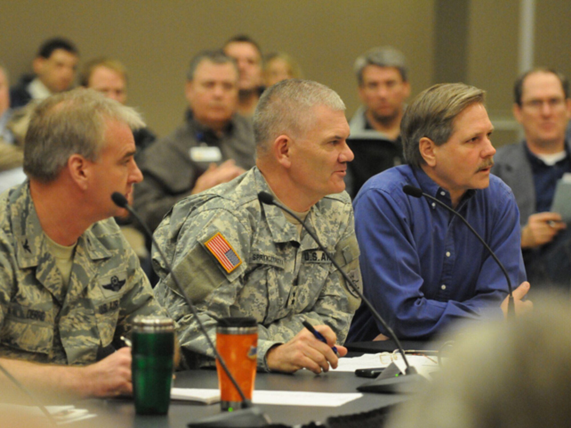 Maj. Gen. David Sprynczynatyk, the North Dakota adjutant general, speaks to community officials March 16 at the Fargo, N.D., City Hall. He is addressing National Guard assistance with flood fighting activities, as Col. Brad Derrig, of the 119th Wing, left, and N.D. Gov. John Hoeven, right, listen.  (DoD photo by Senior Master Sgt. David H. Lipp) (Released)

